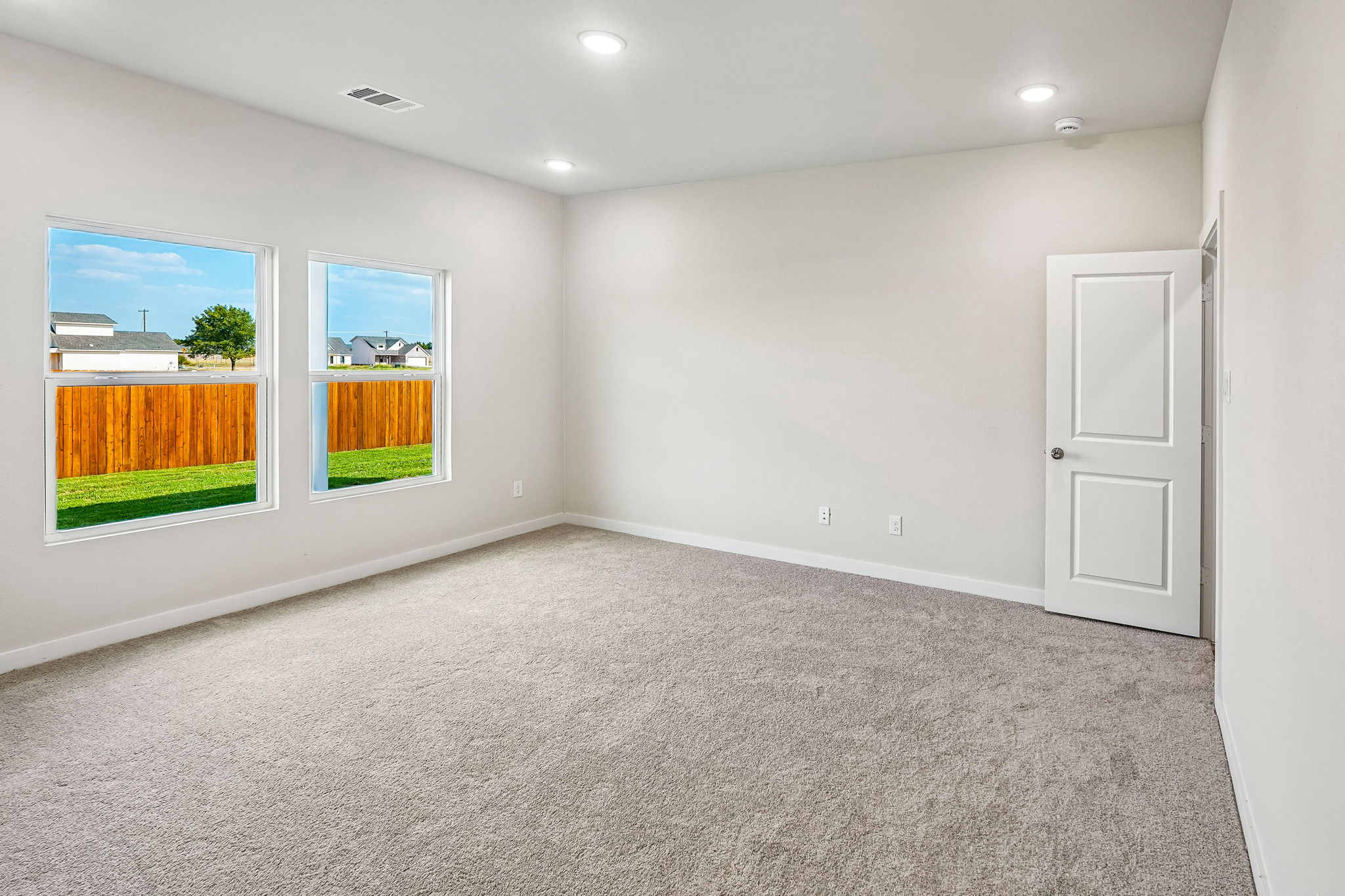 A room with a door and windows.