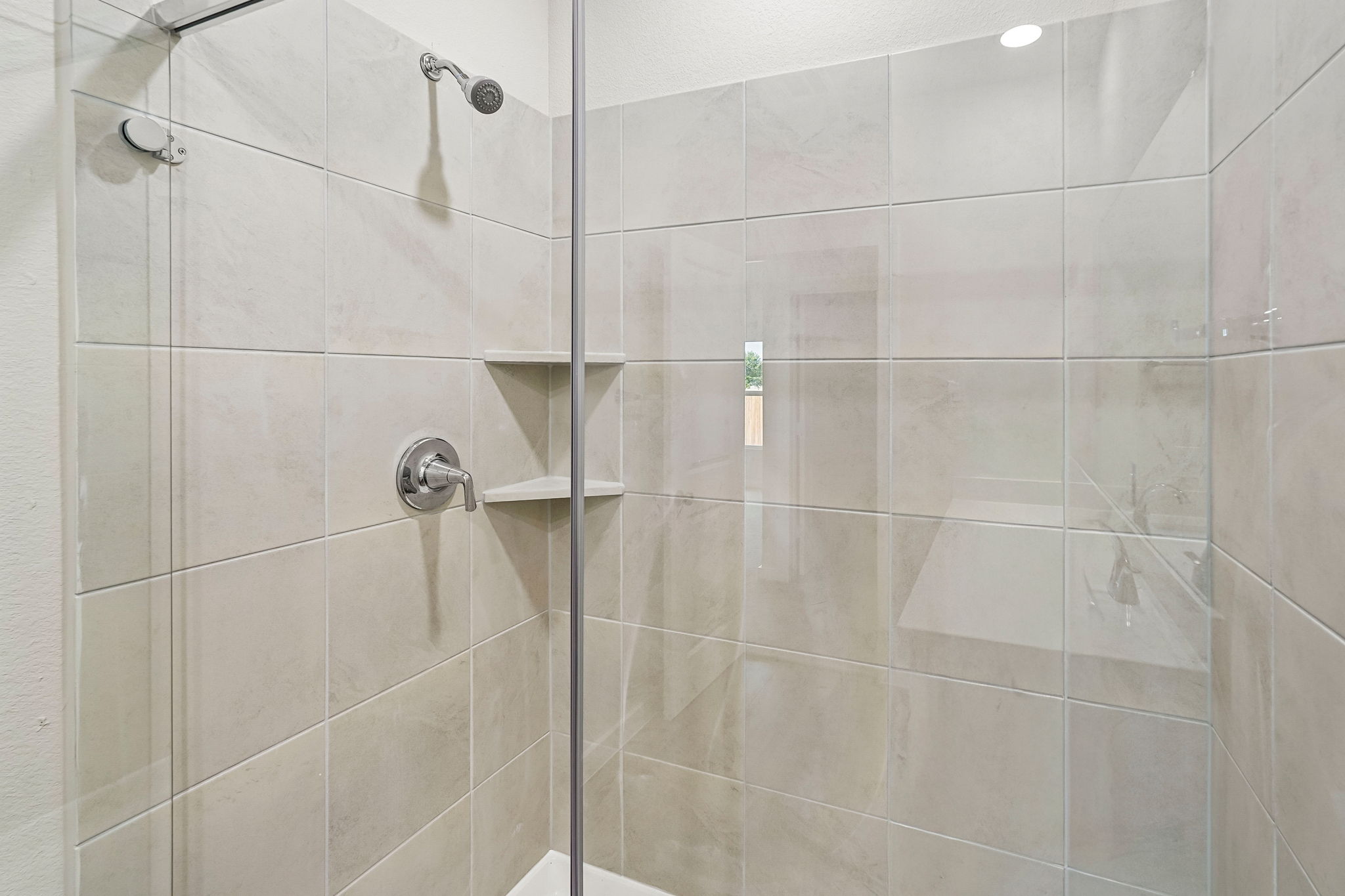 A shower with a glass door.