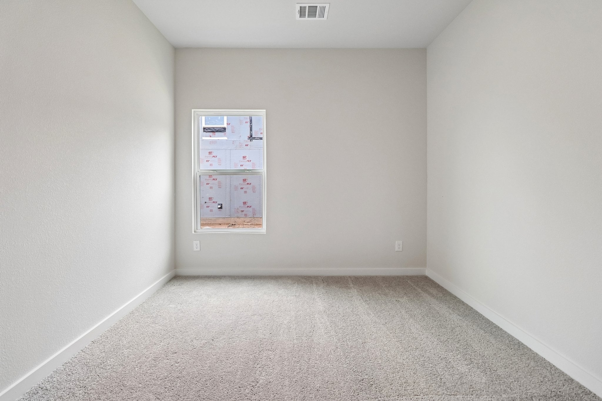 A white wall with a poster on it.