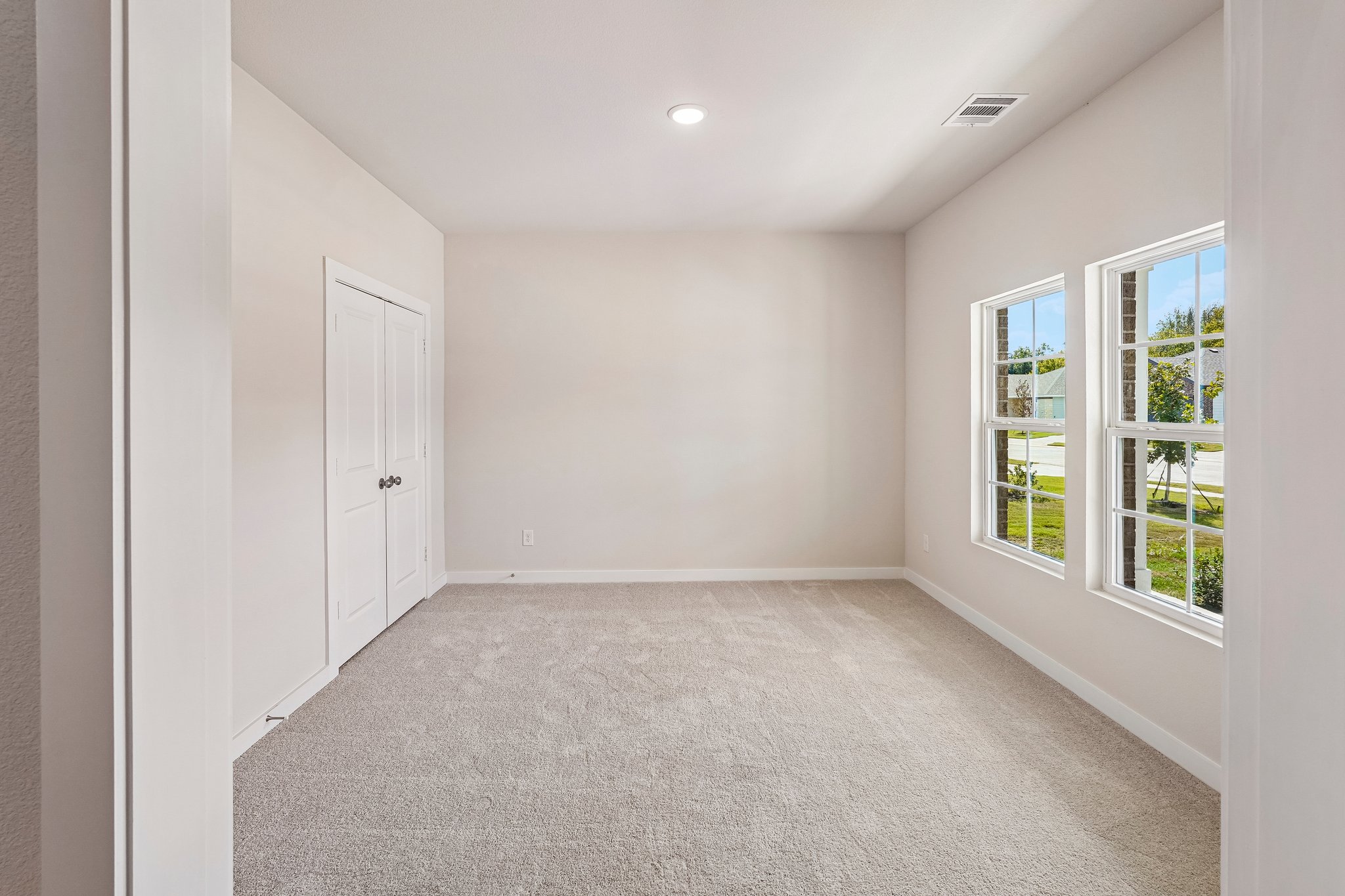A room with white walls and windows.