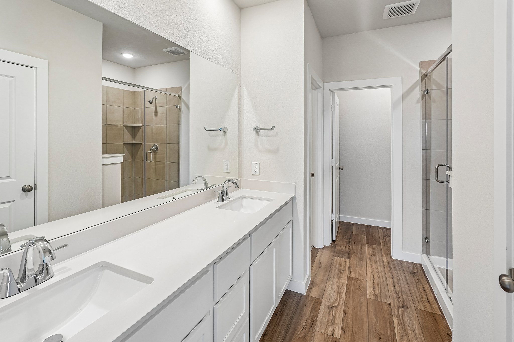 A bathroom with a large mirror.