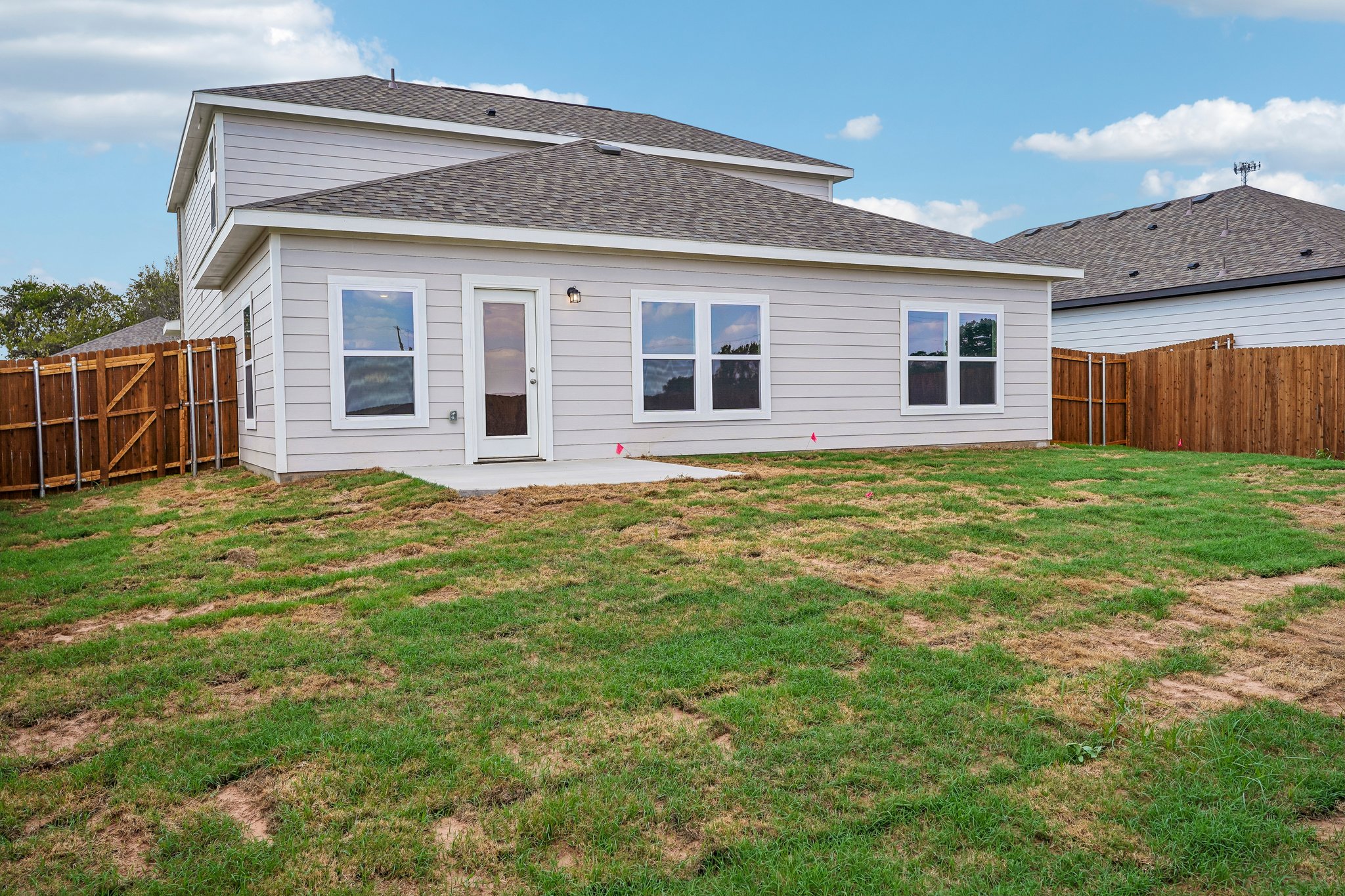 A house with a fence and grass.
