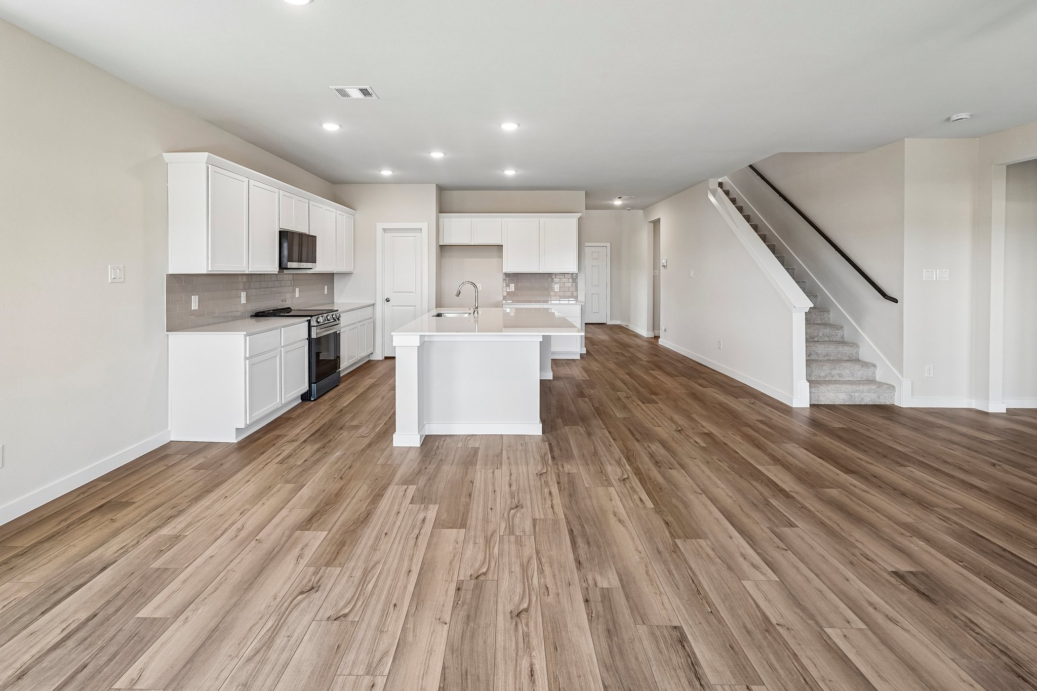A large kitchen with white cabinets.