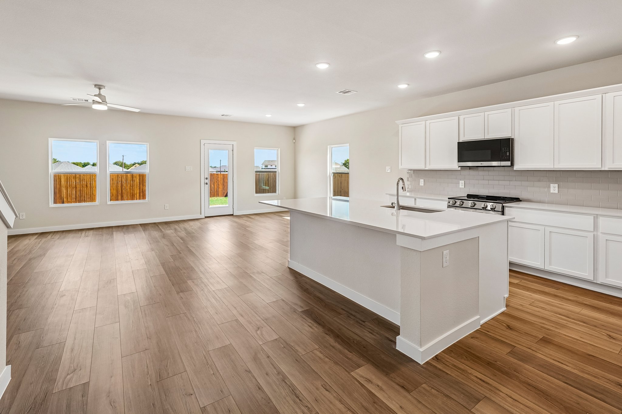 A kitchen with white cabinets.
