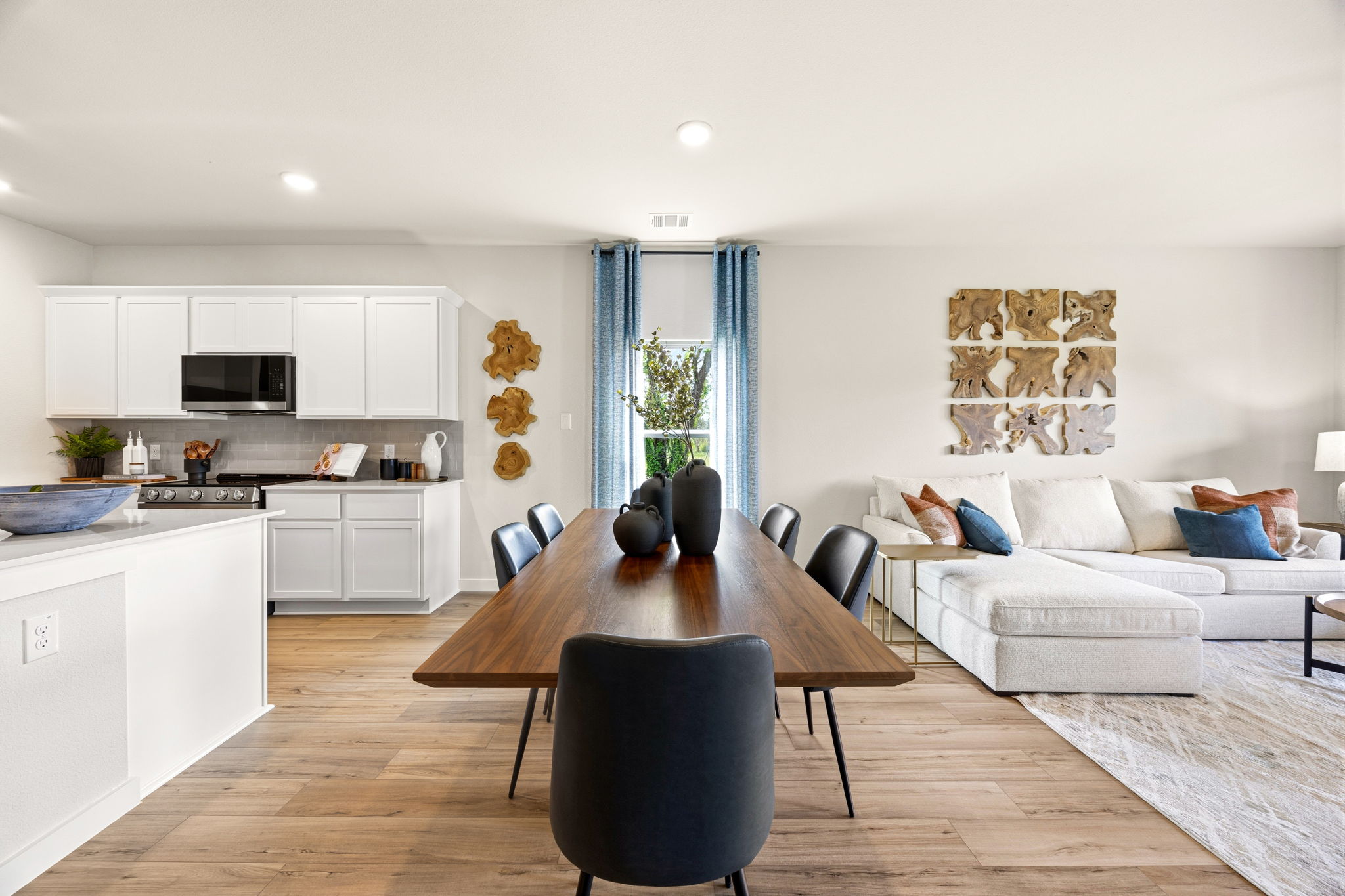 A living room with a table and chairs.