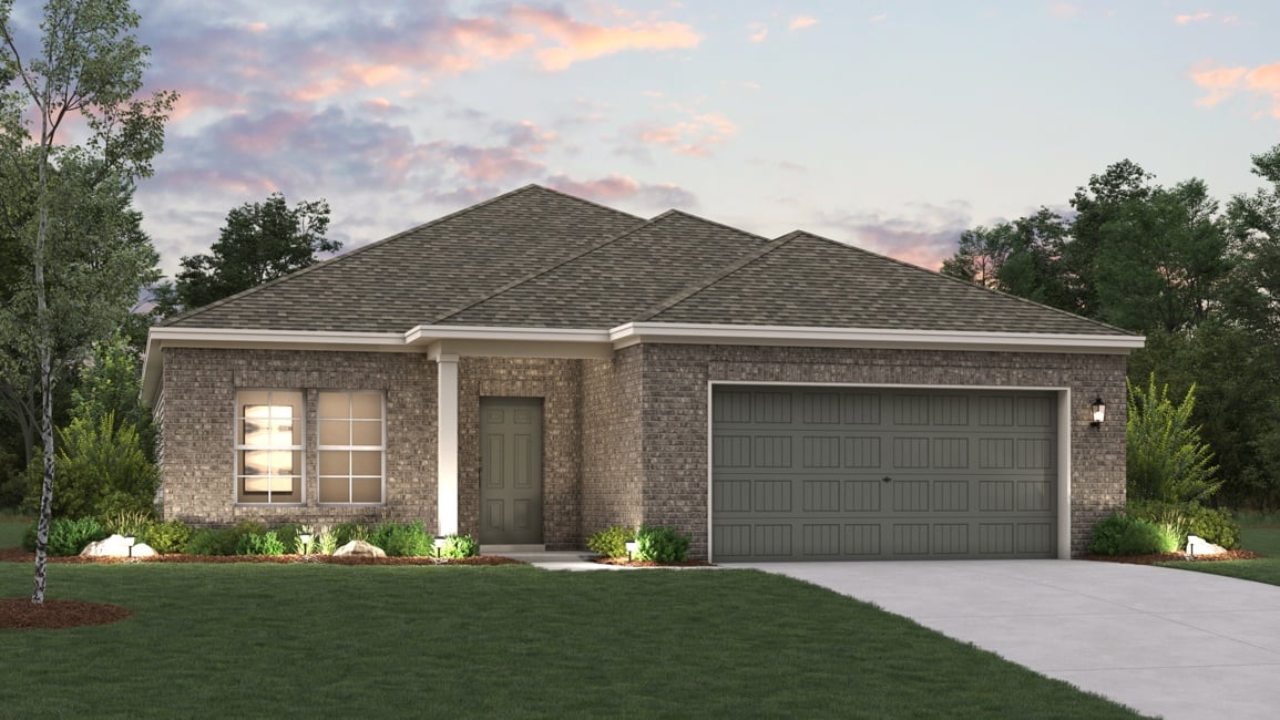 A house with a garage and a lawn in front of it.