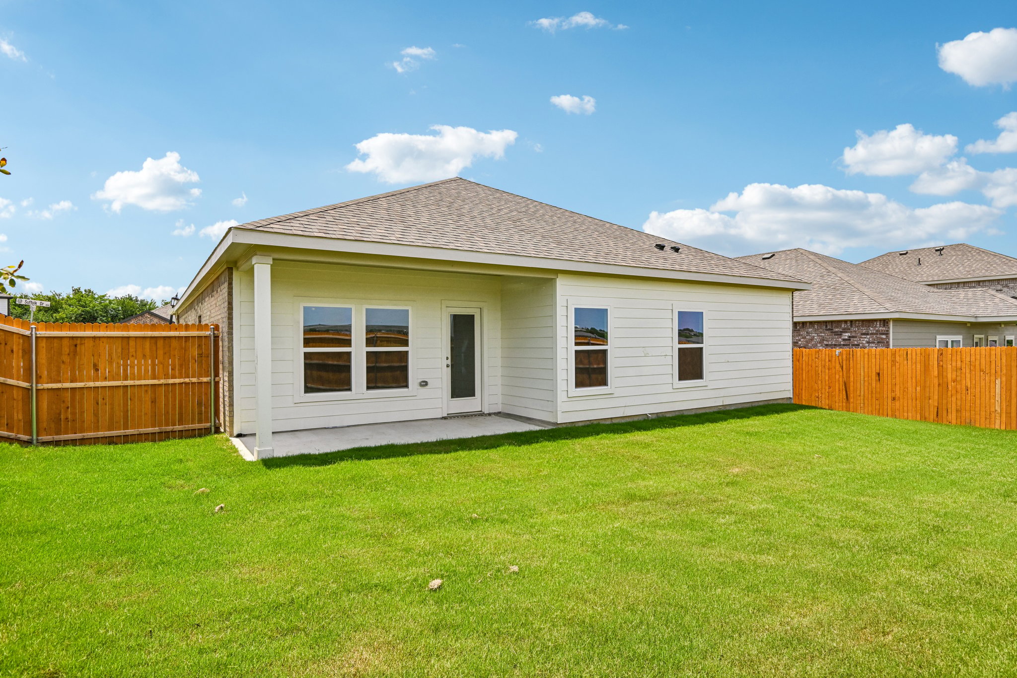 A house with a fence and grass.