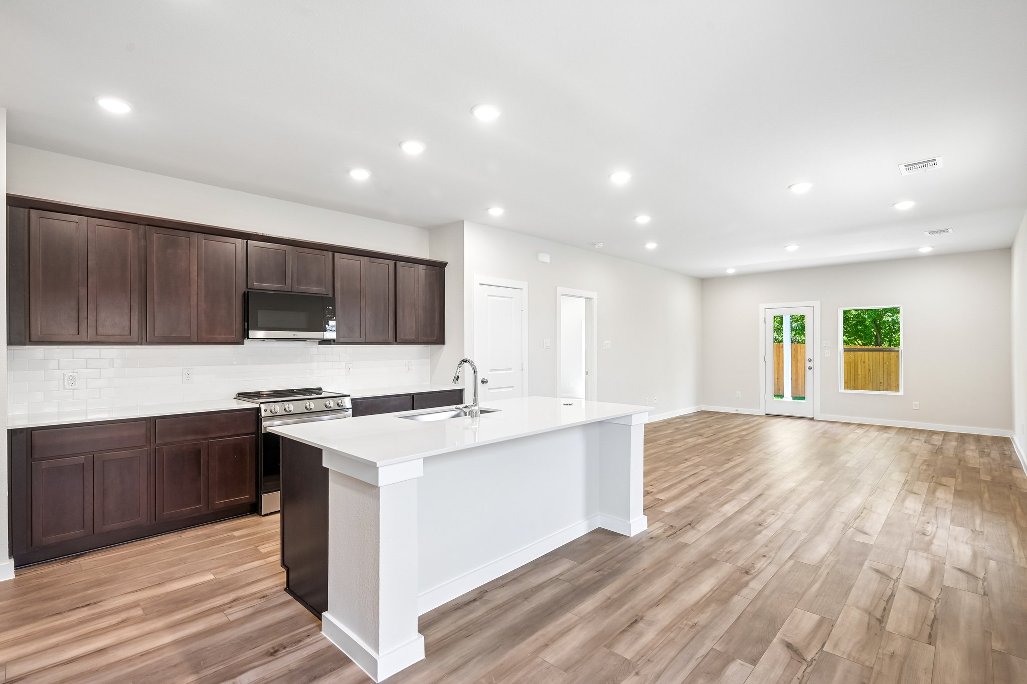 A kitchen with wooden cabinets.