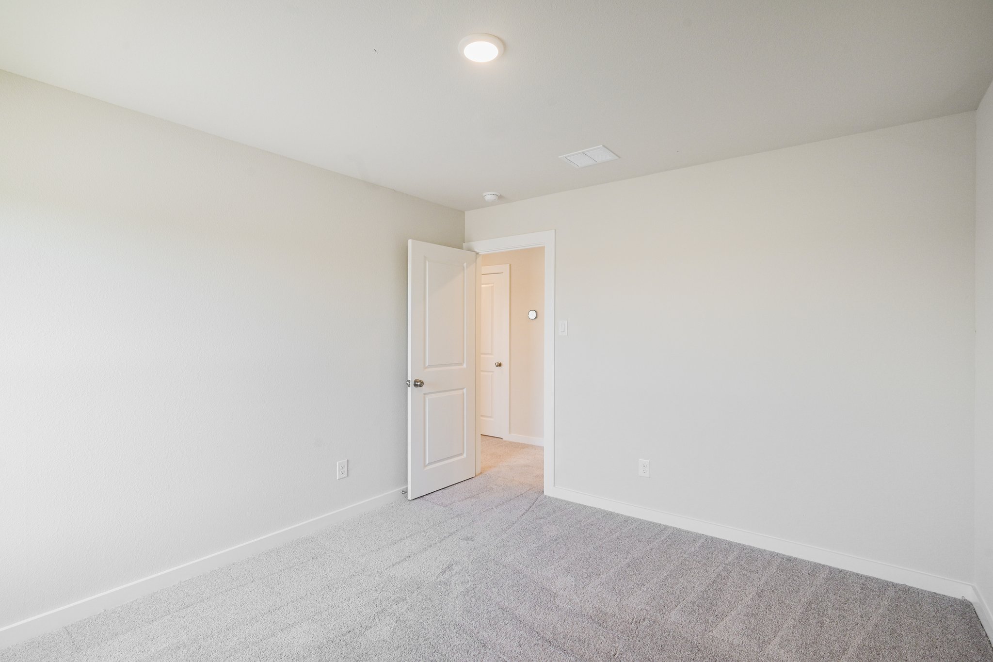 A hallway with white walls.