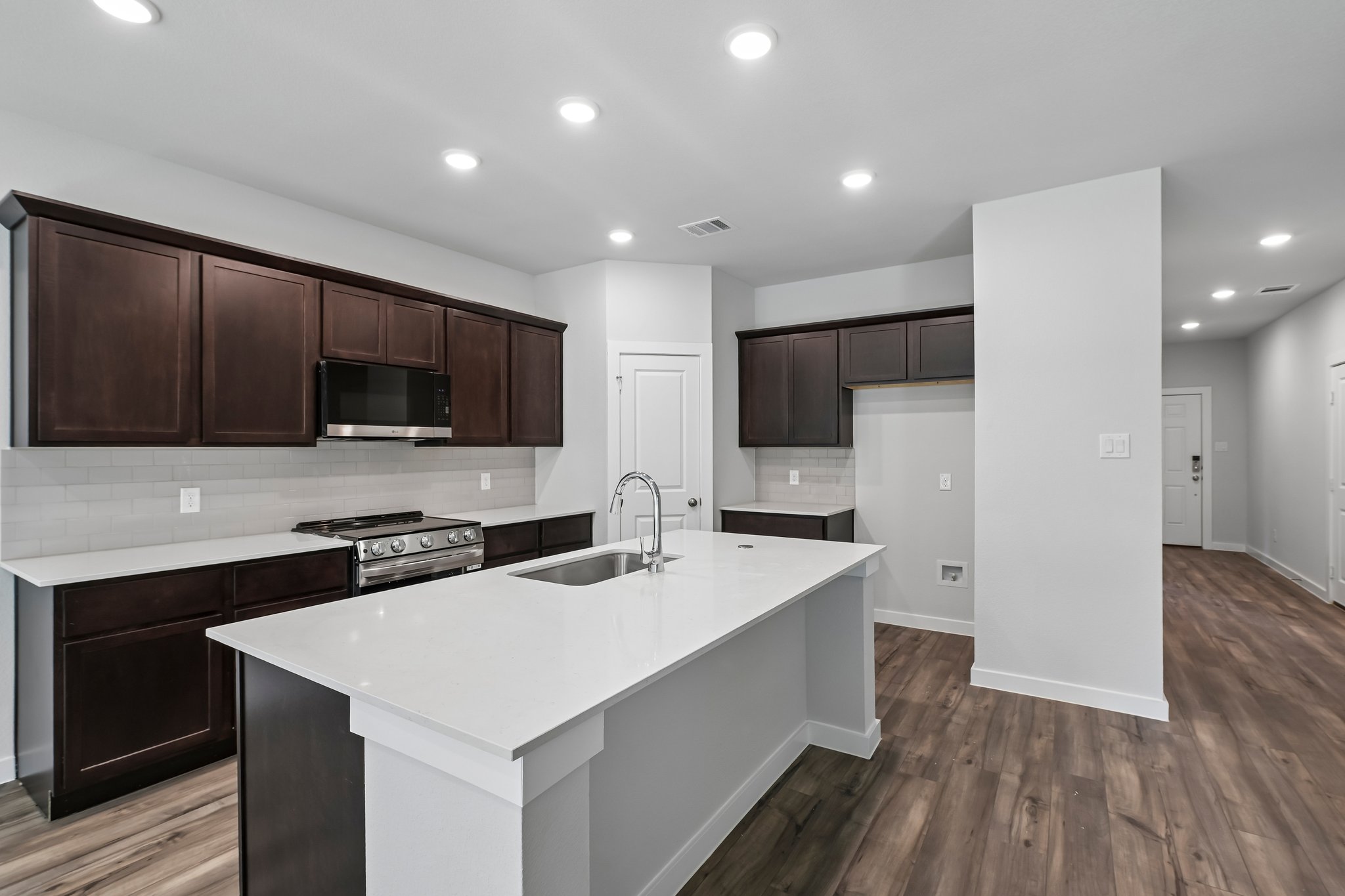 A kitchen with wooden cabinets.
