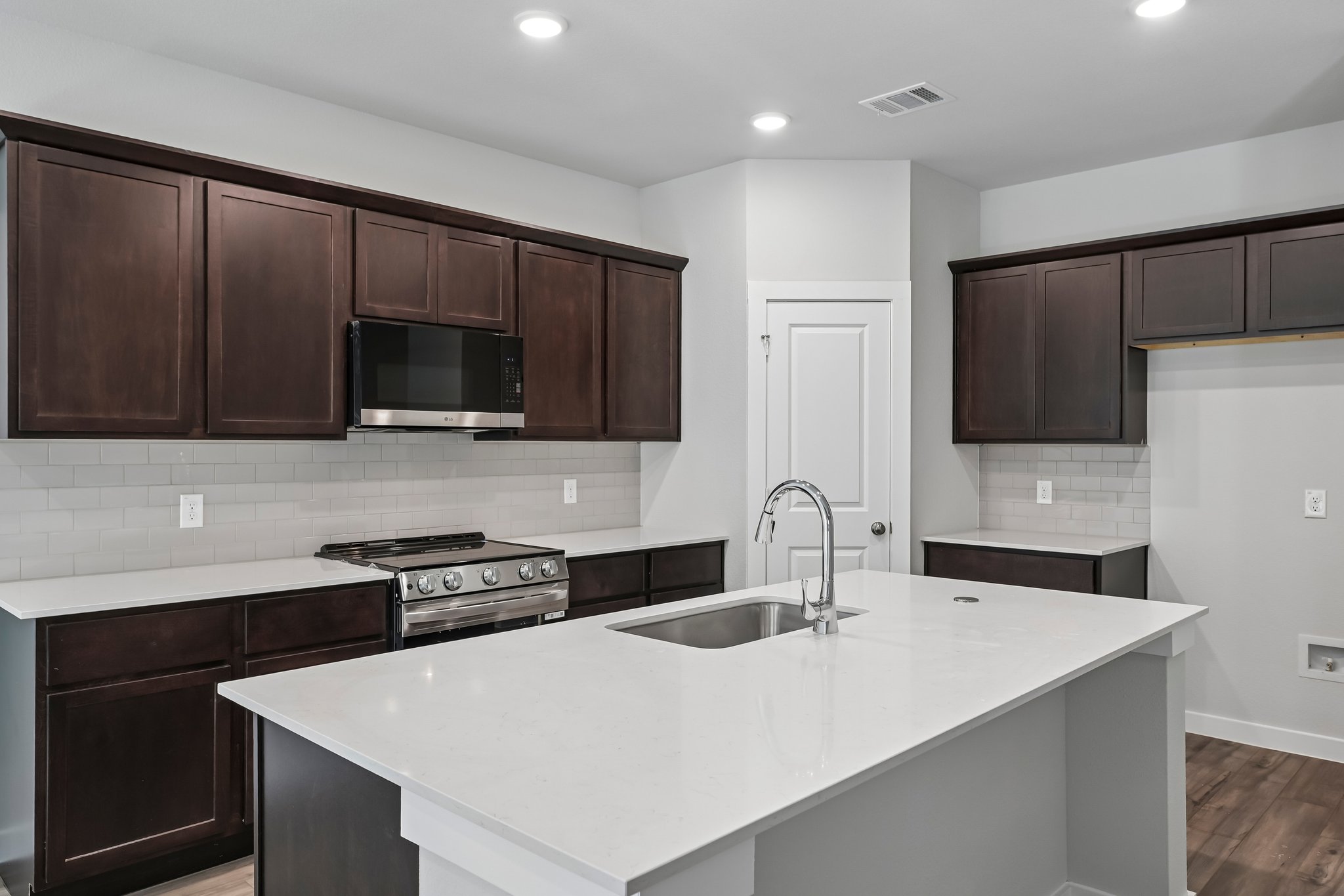 A kitchen with black cabinets.