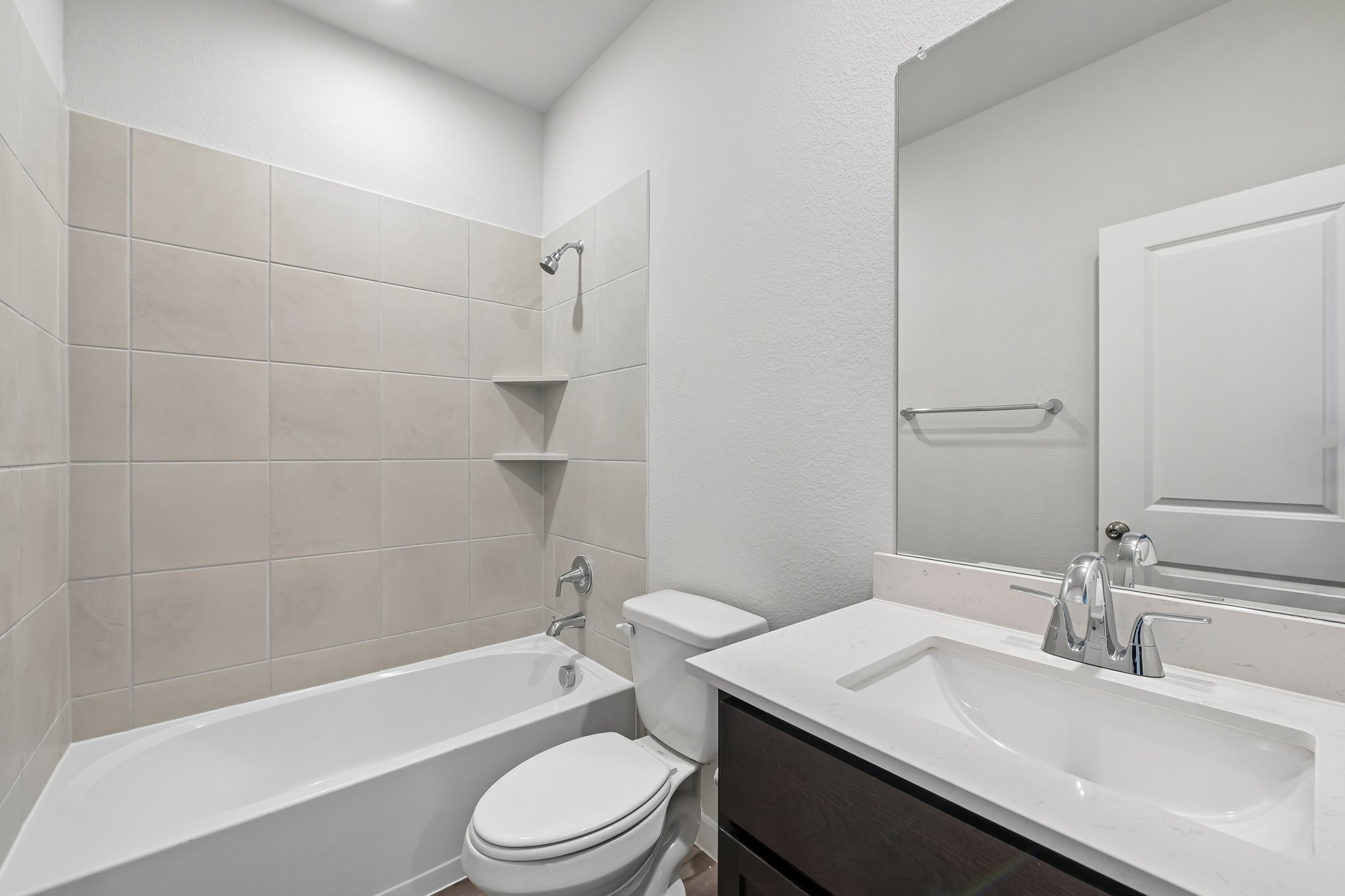 A bathroom with a tub sink and toilet.