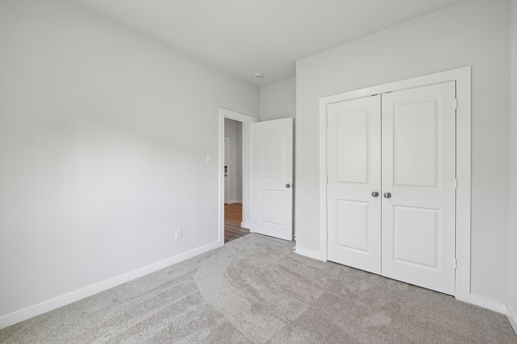A hallway with white doors.