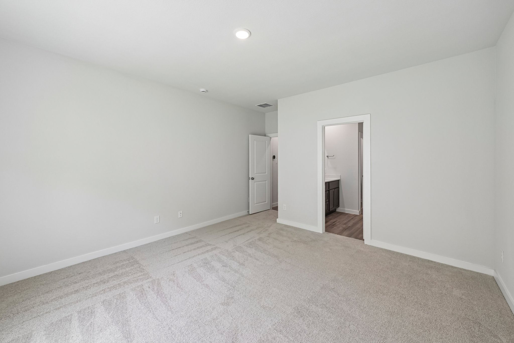 A hallway with white walls.