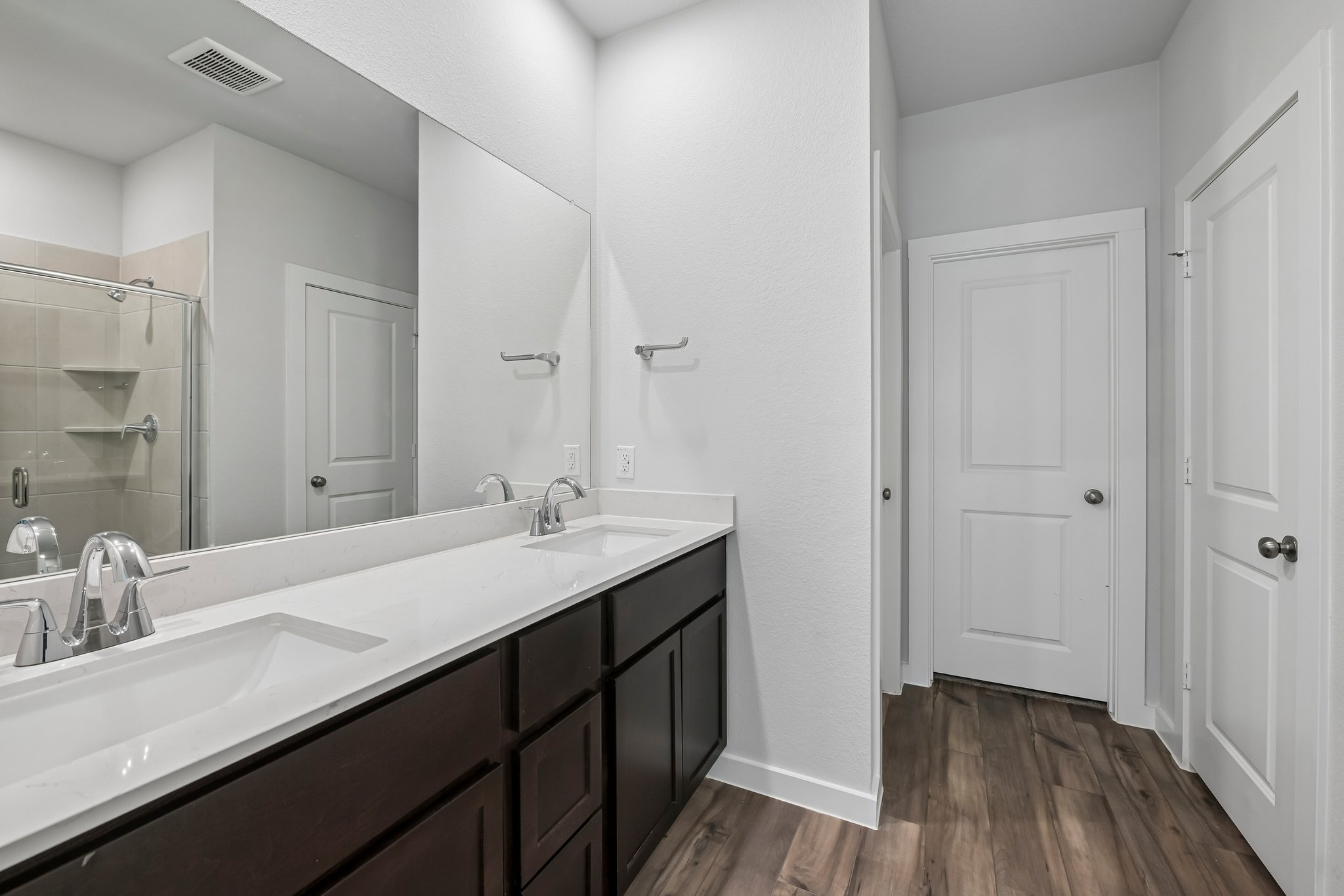 A bathroom with a large mirror.