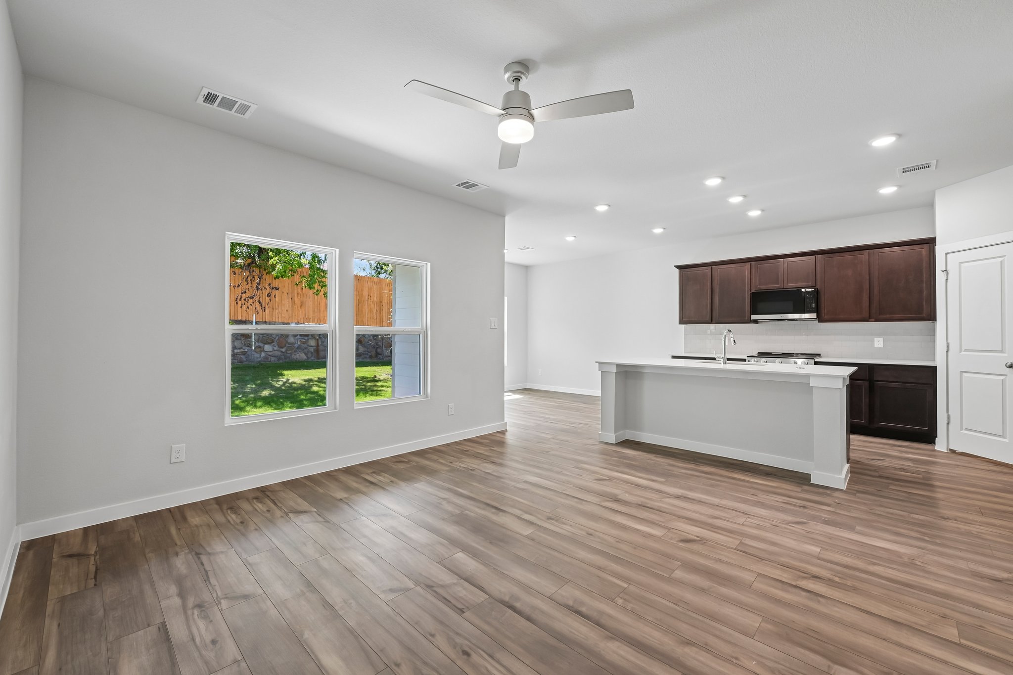 A kitchen with a wood floor.