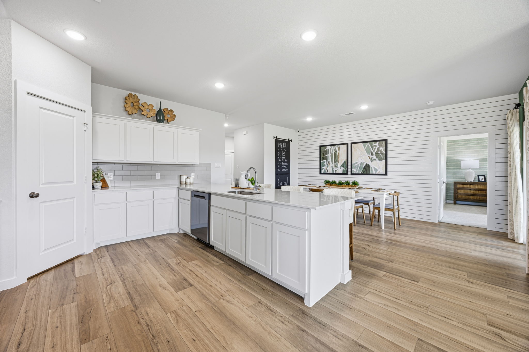 A large kitchen with white cabinets.