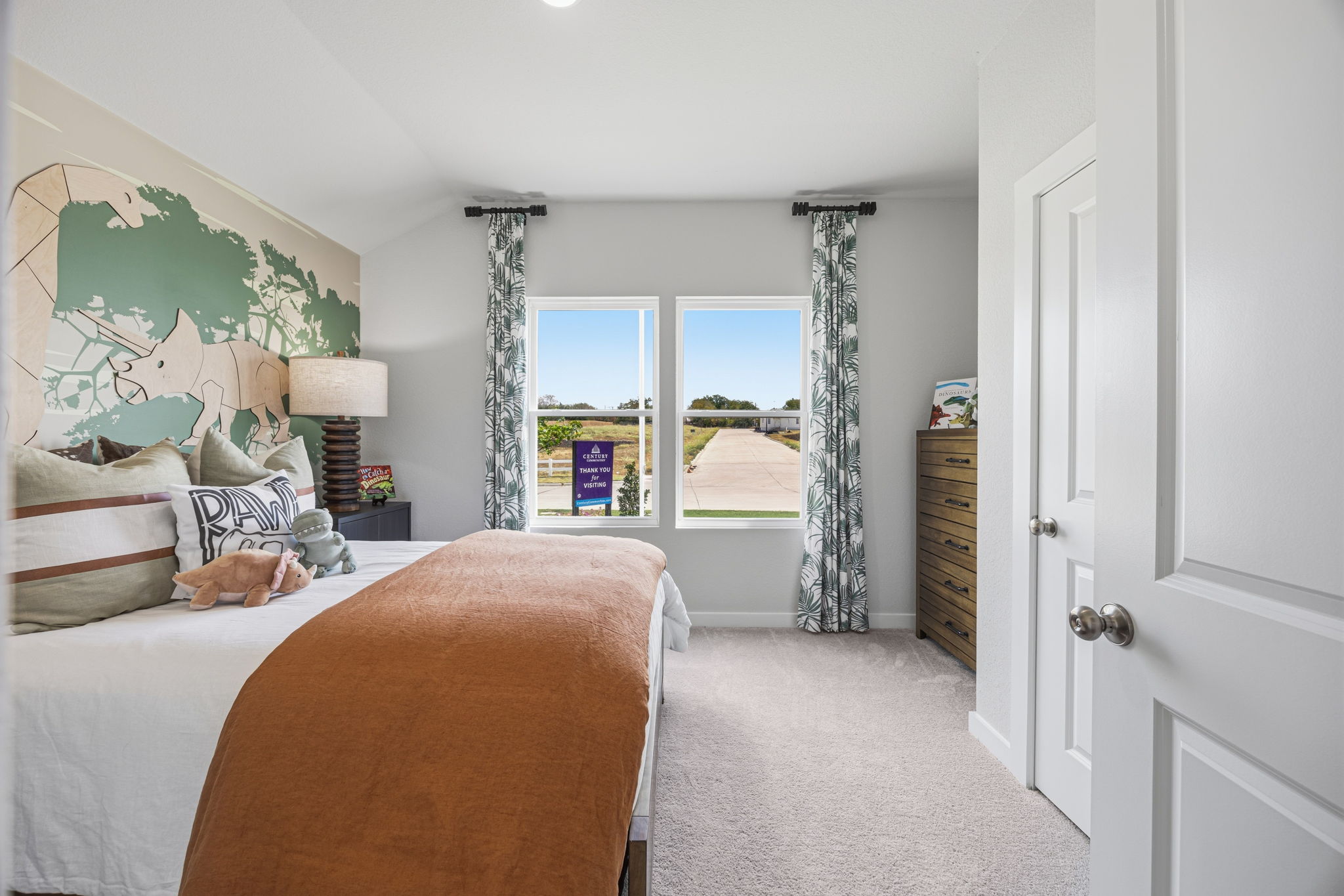 A bedroom with a large window.