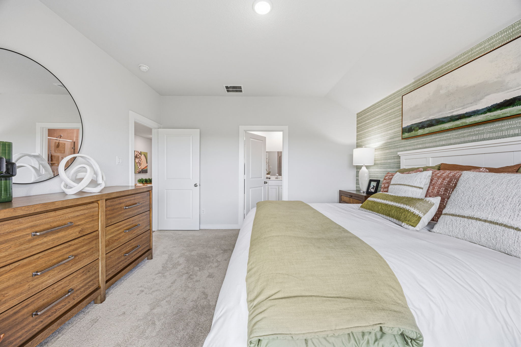 A bedroom with a bed and a dresser.