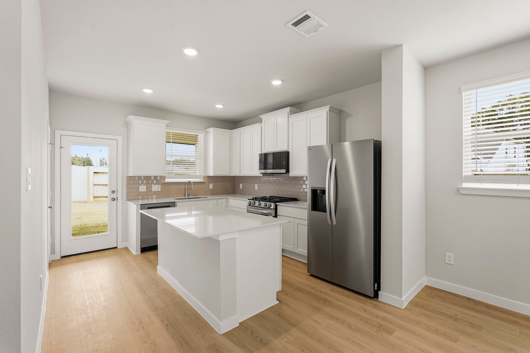 A kitchen with white cabinets.