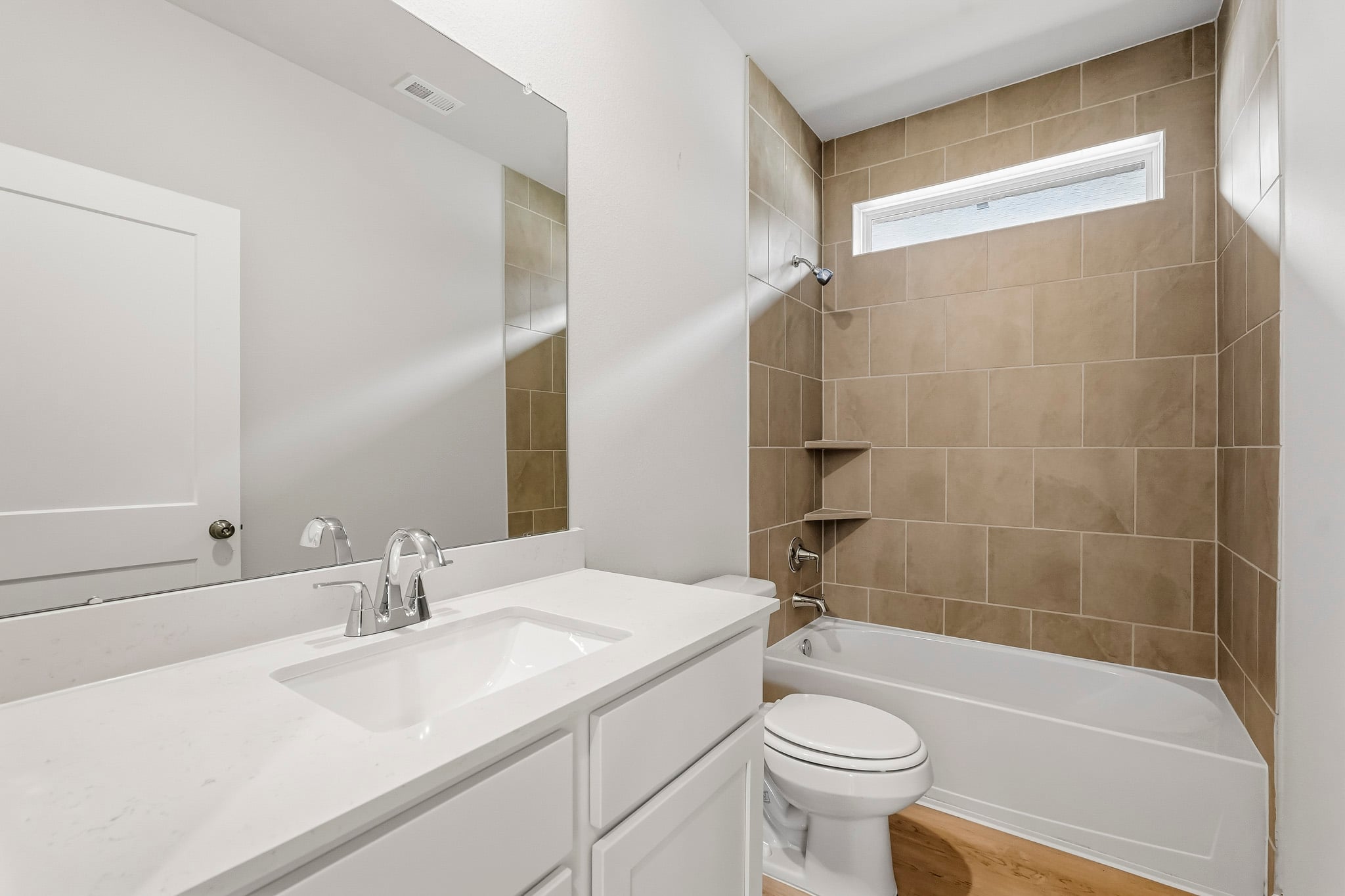 A bathroom with a tub sink and toilet.