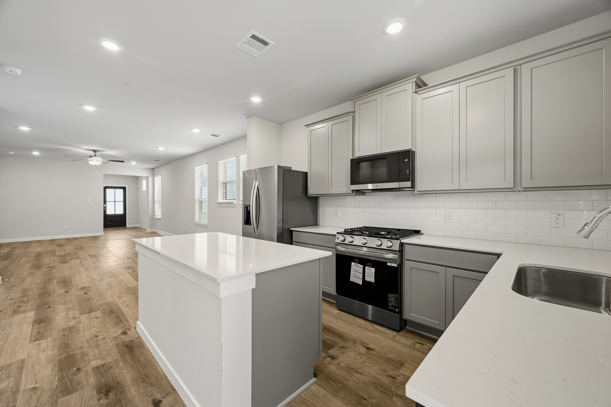 A kitchen with white cabinets.