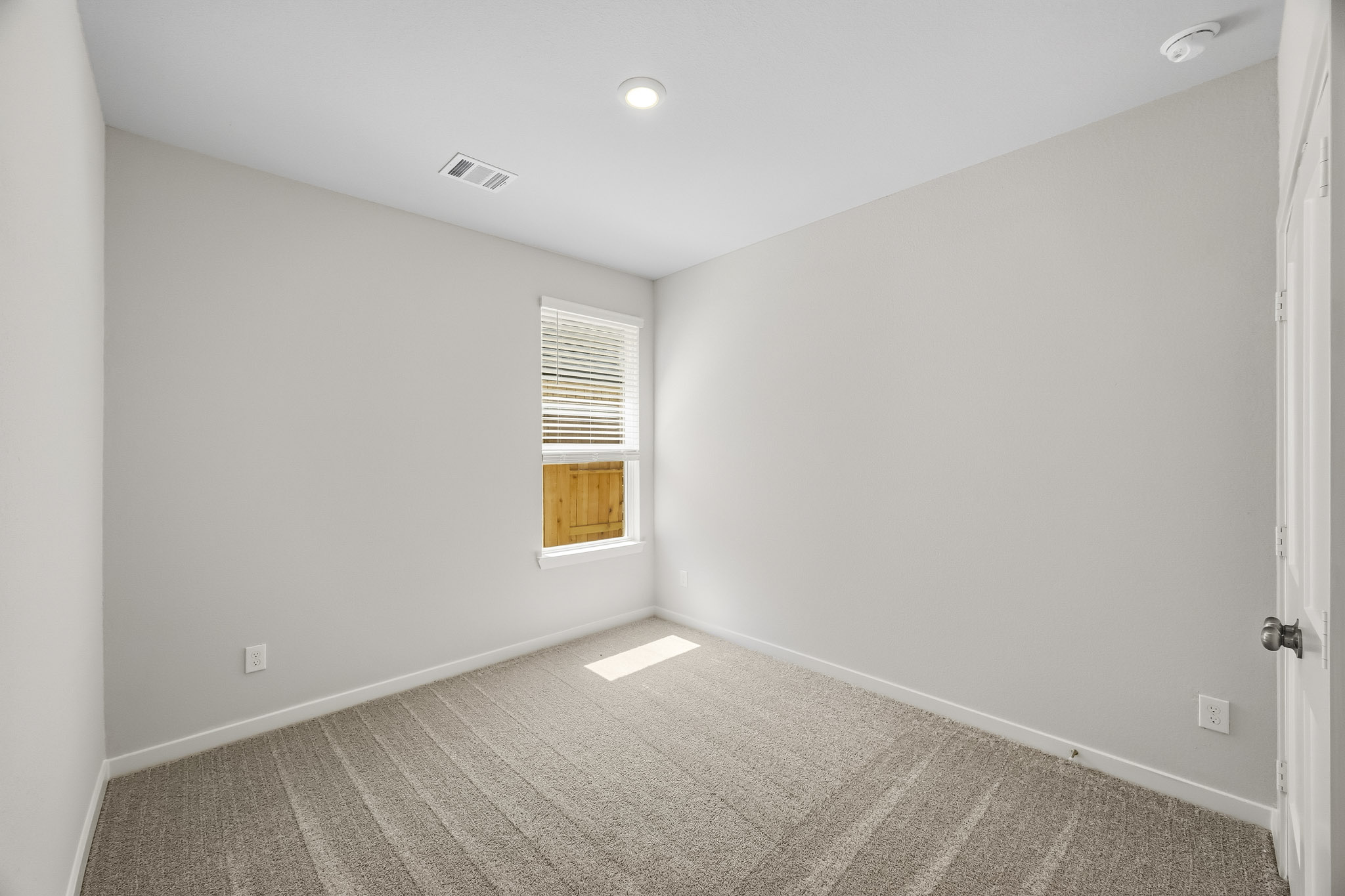 A room with a door and a window.