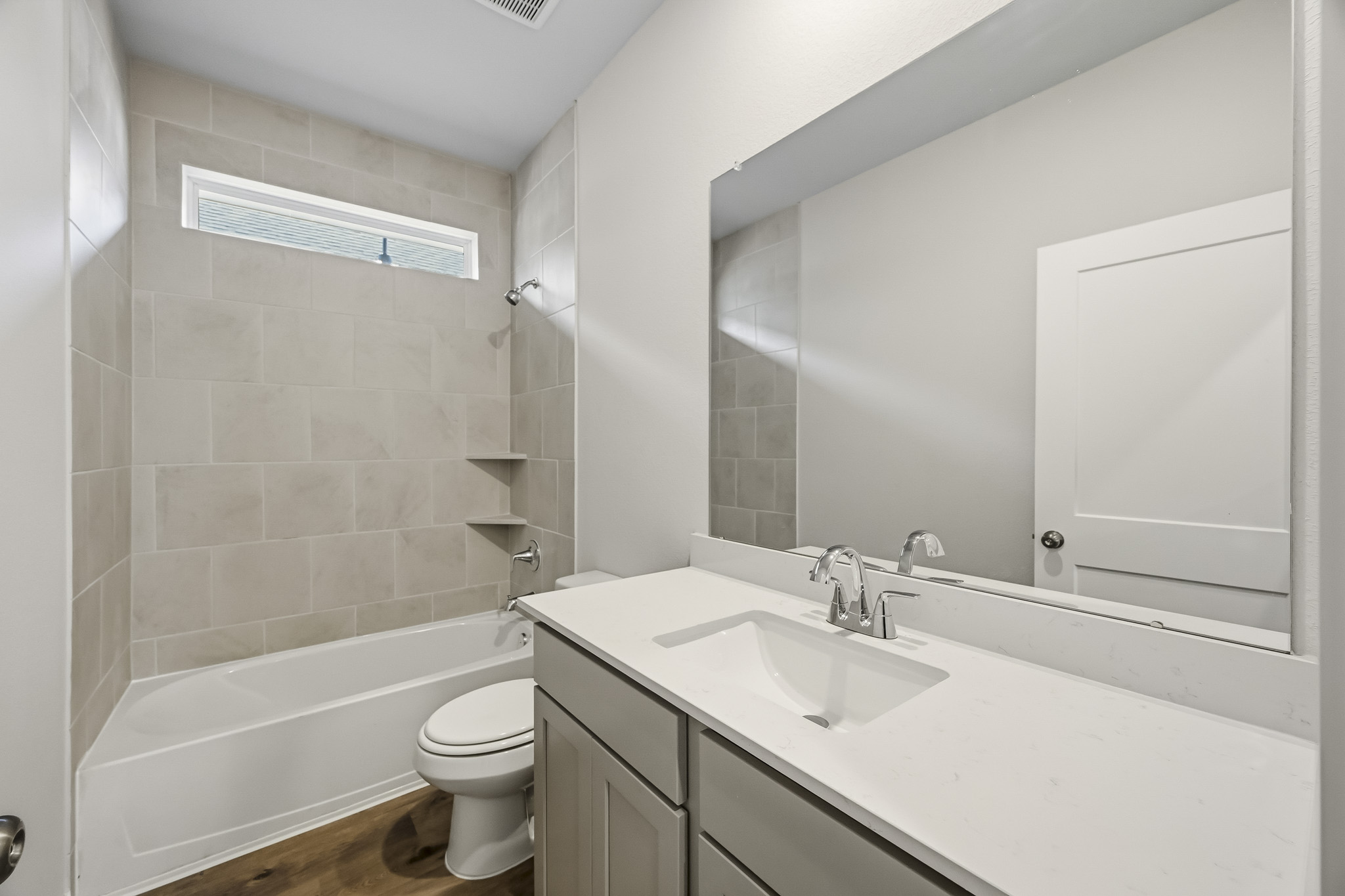 A bathroom with a tub sink and toilet.