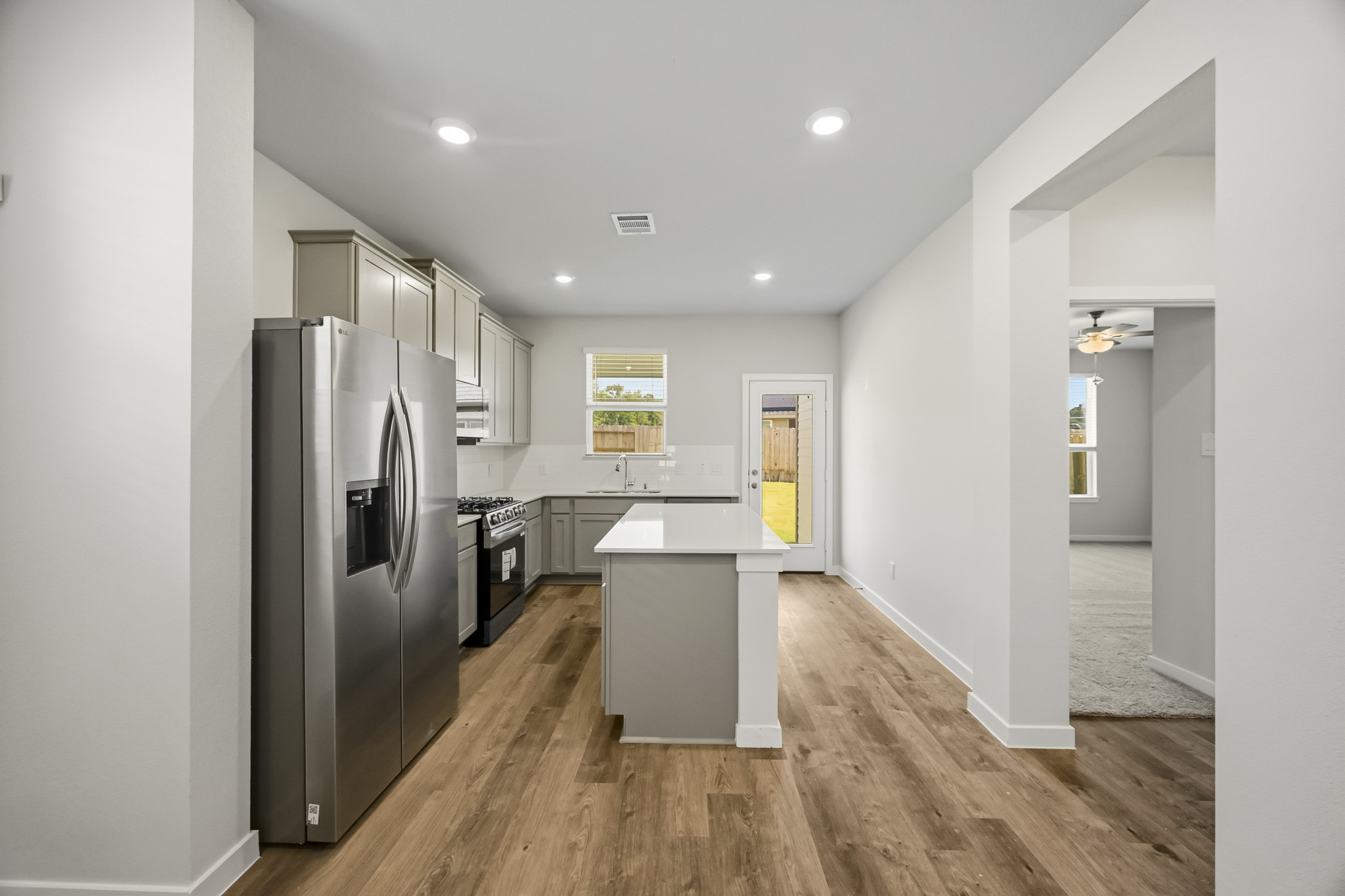 A kitchen with white cabinets.
