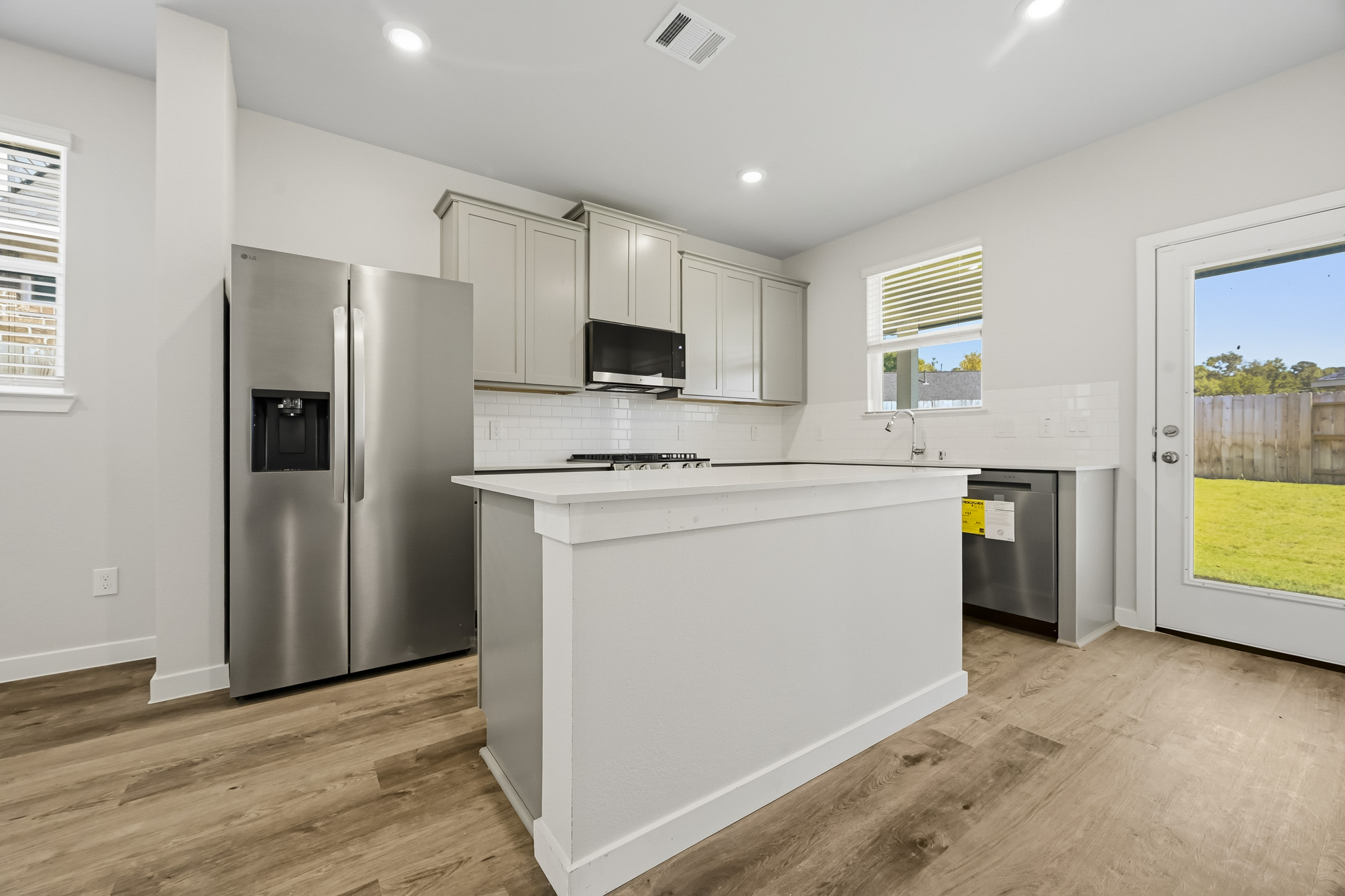 A kitchen with white cabinets.