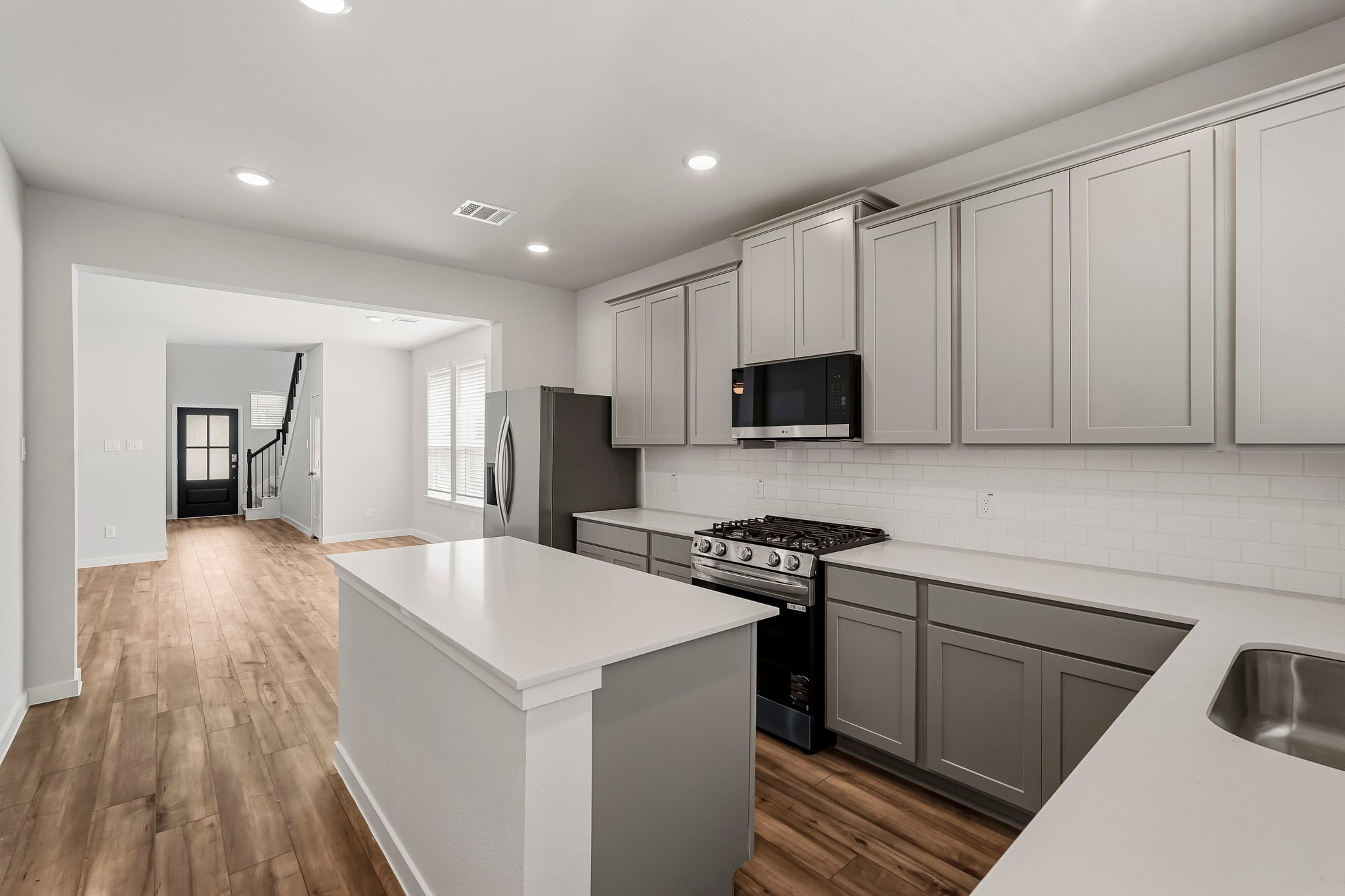 A kitchen with white cabinets.