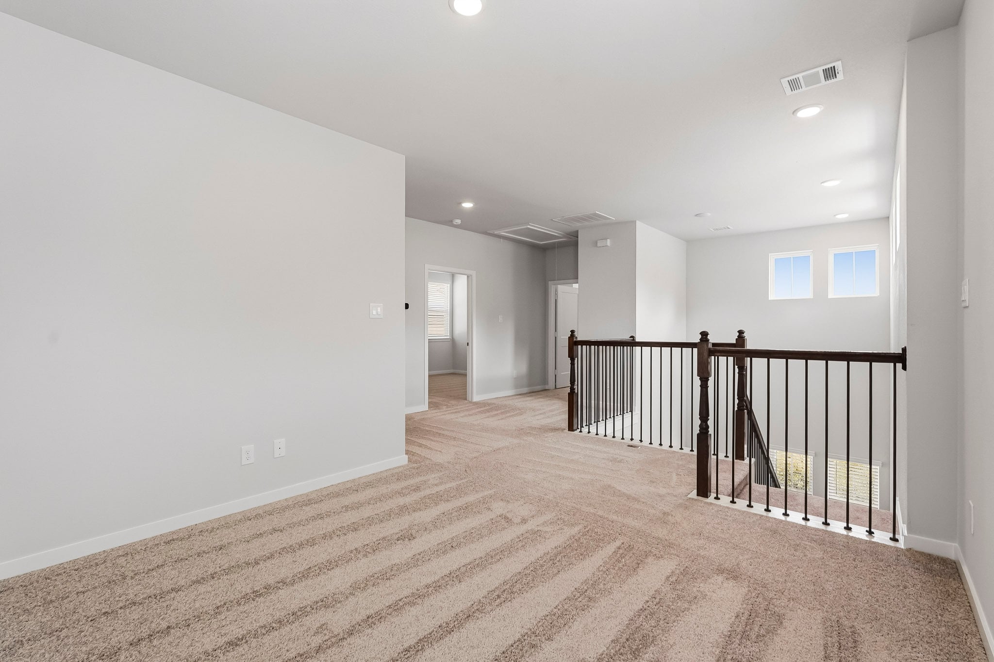 A long hallway with a railing.