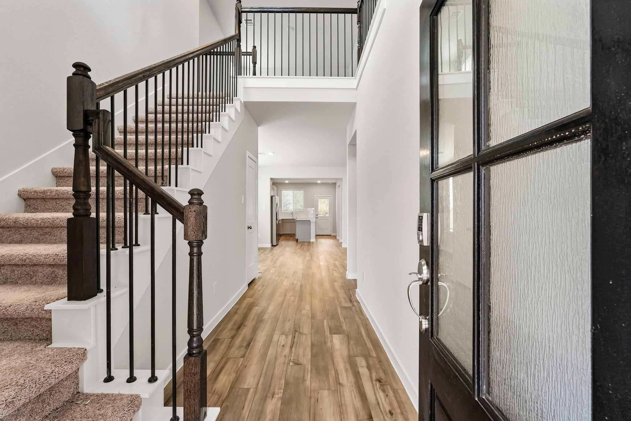 A long hallway with black railings.