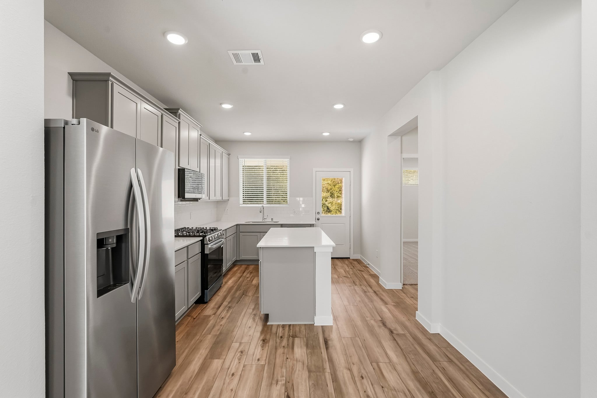 A kitchen with white cabinets.