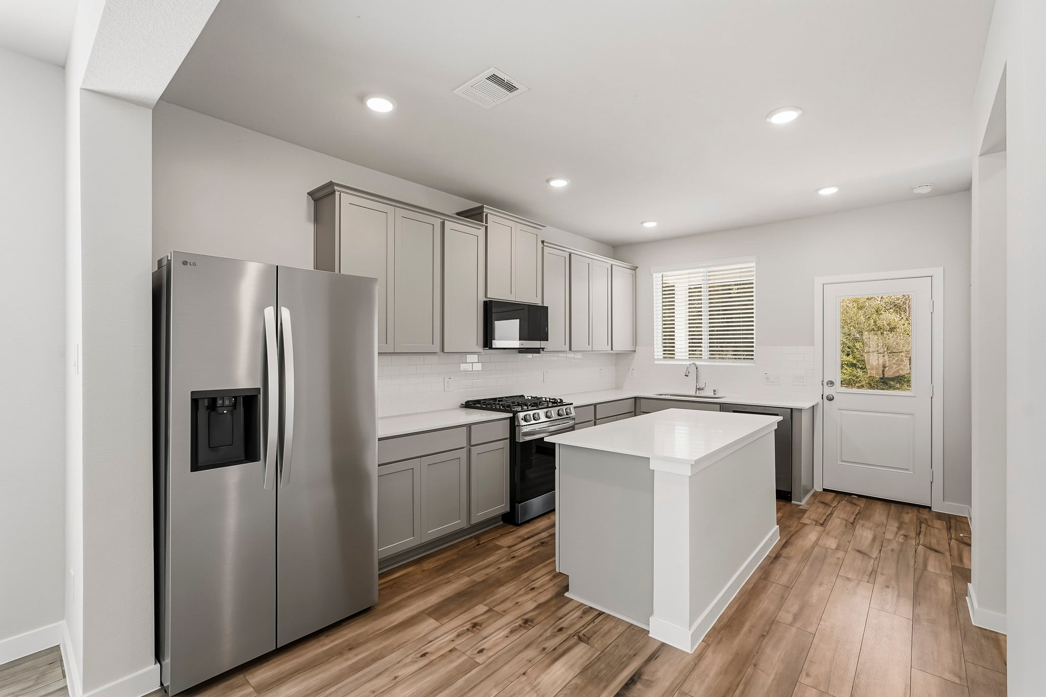 A kitchen with white cabinets.