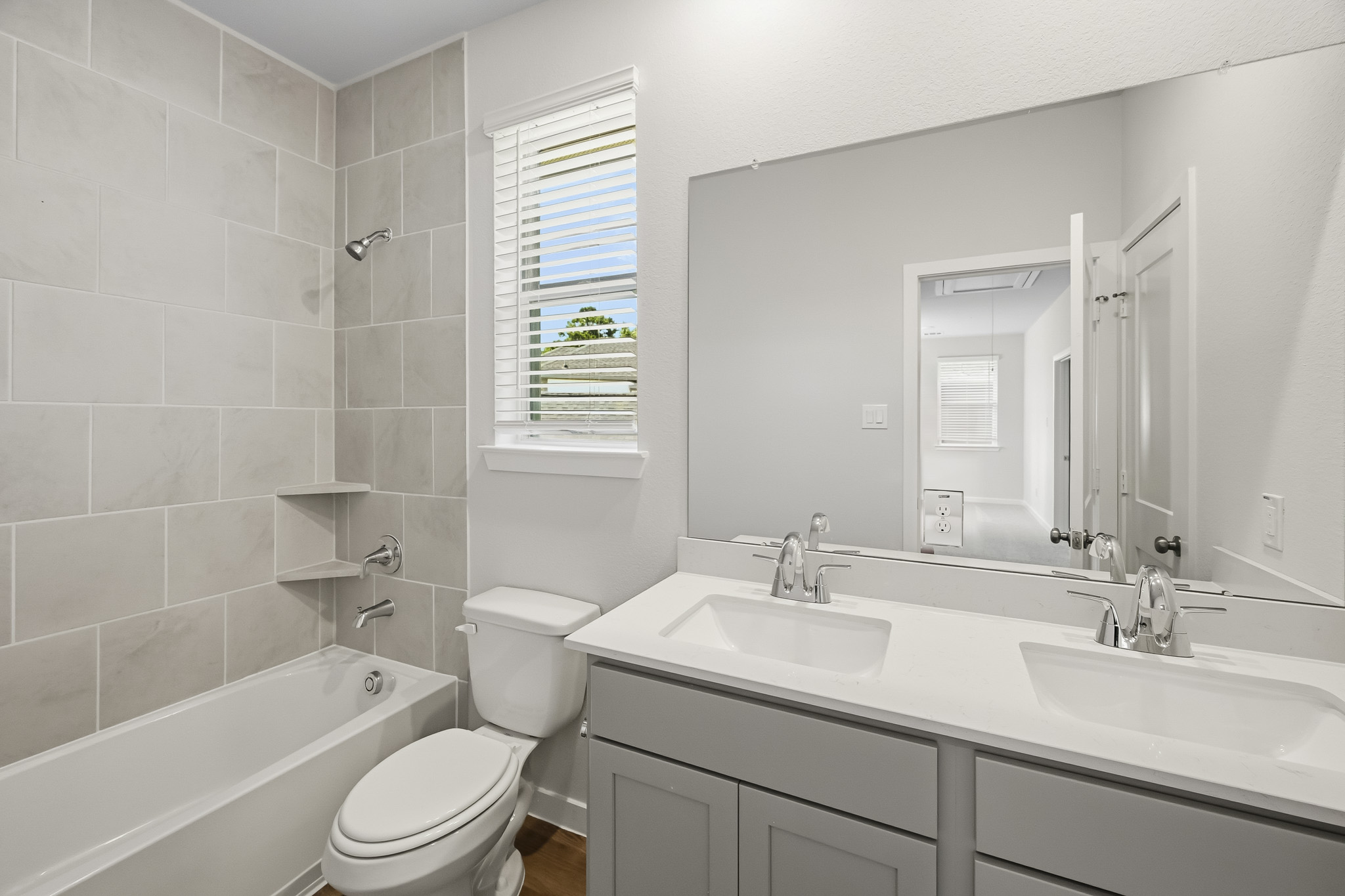 A bathroom with a tub sink and toilet.