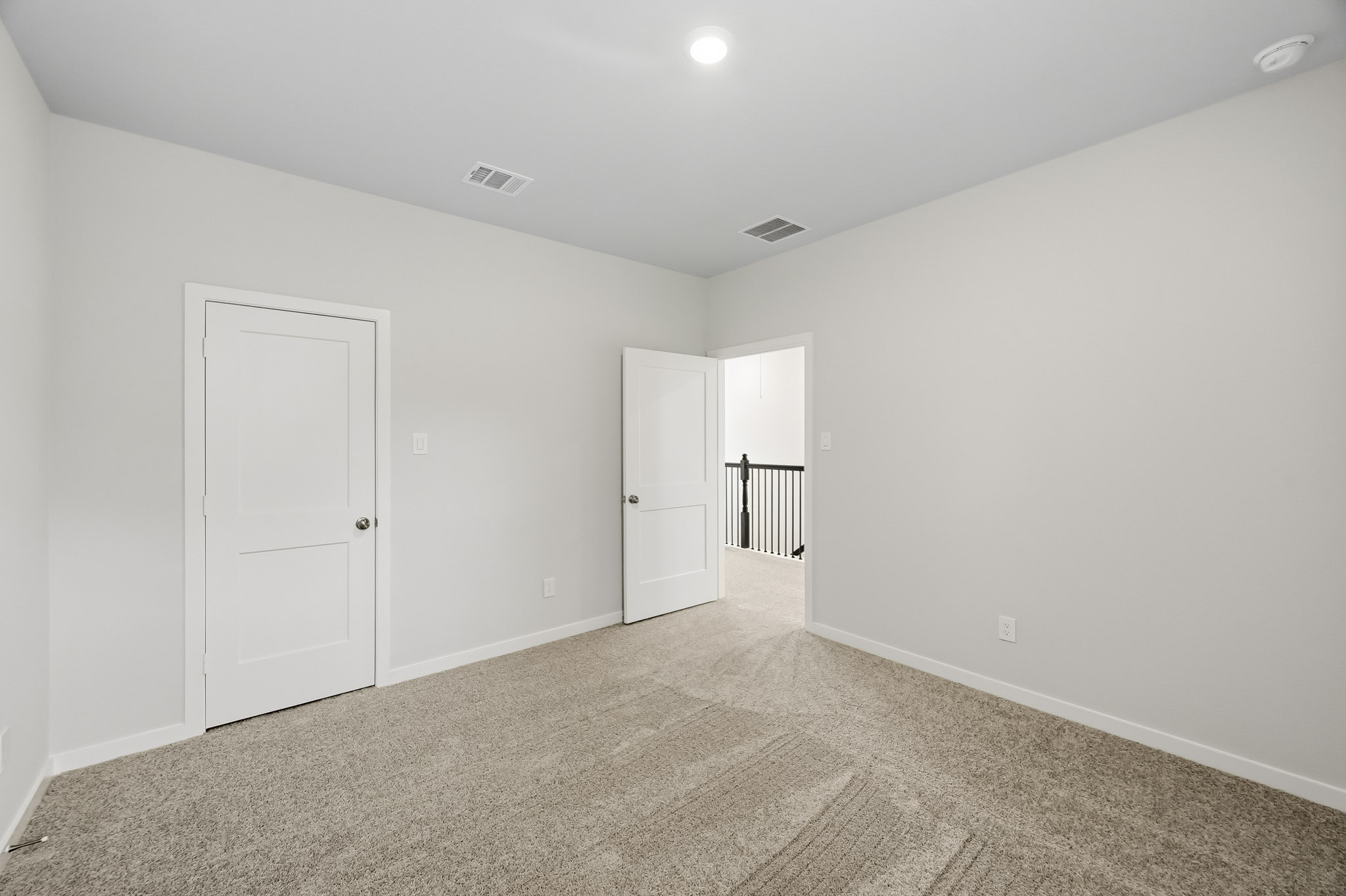 A hallway with white doors.