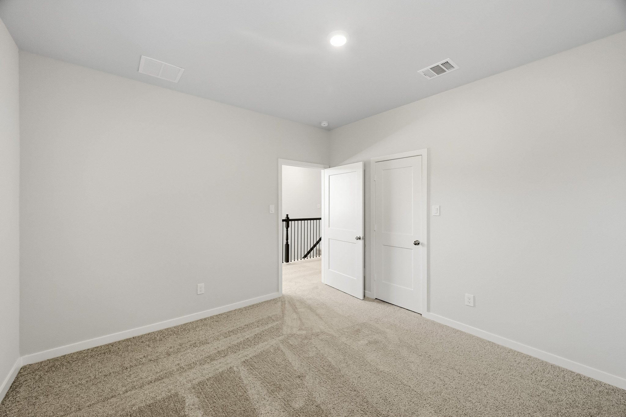 A hallway with white doors.