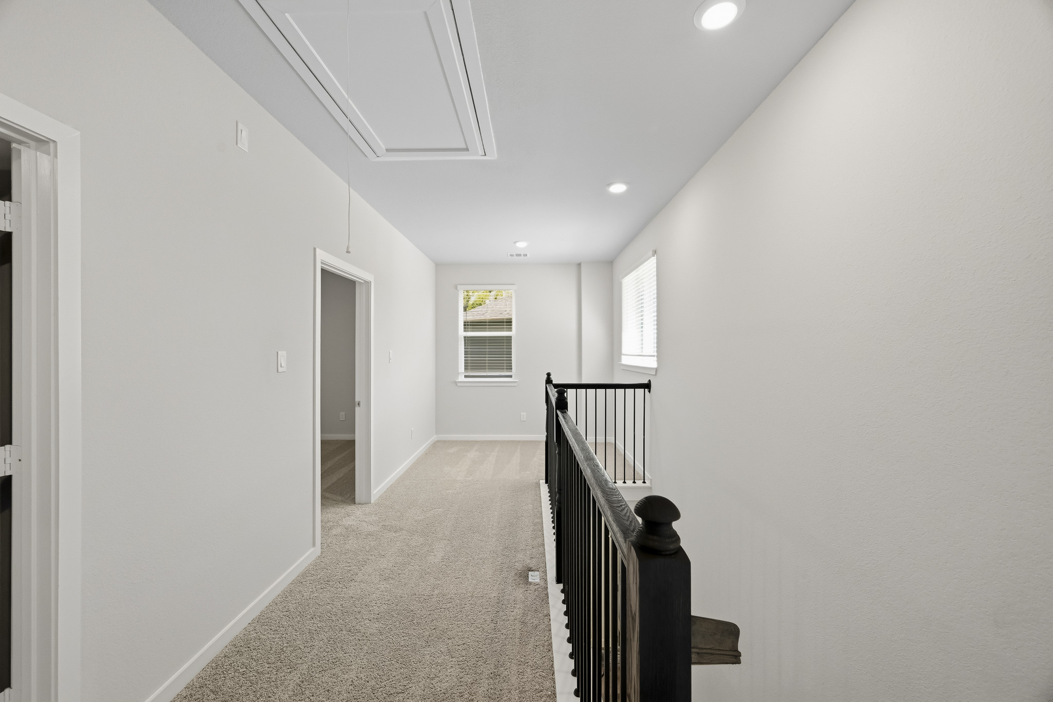 A hallway with a staircase.