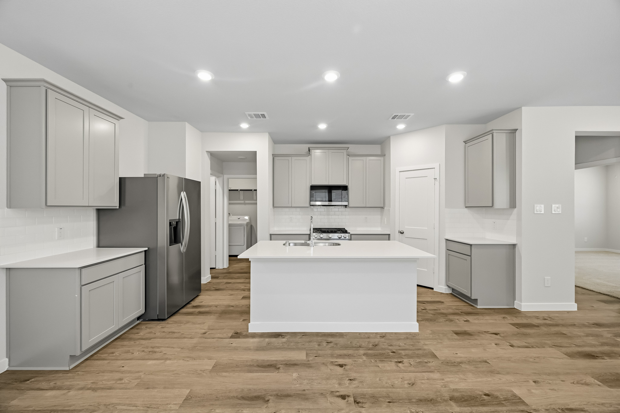 A kitchen with white cabinets.