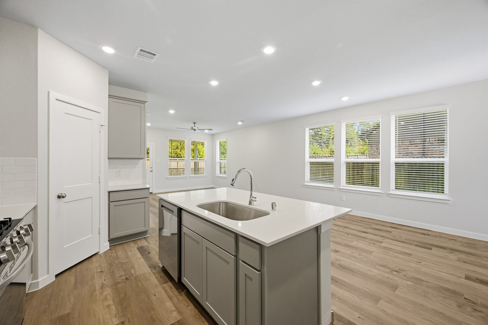 A kitchen with white cabinets.