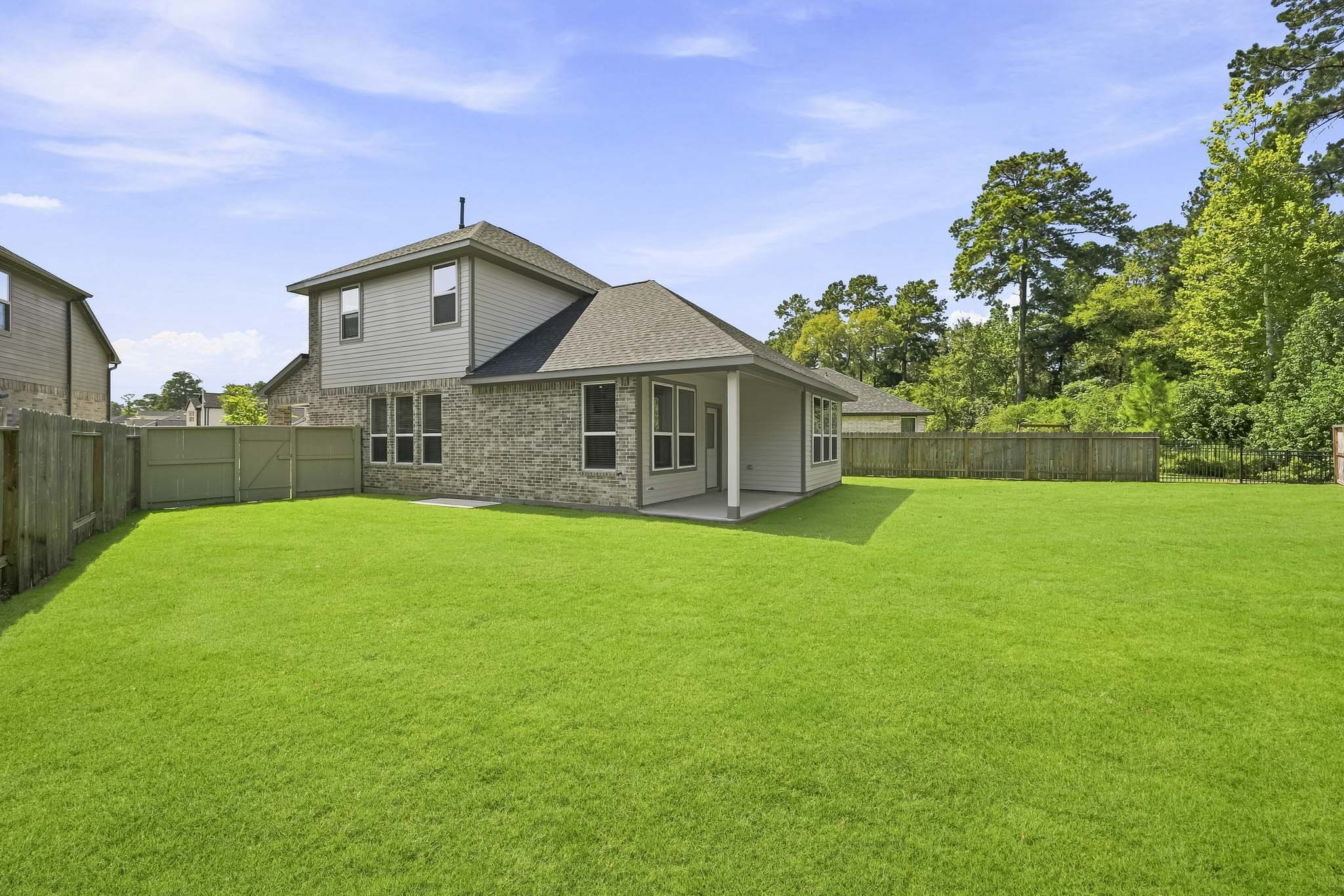 A house with a fence and trees.