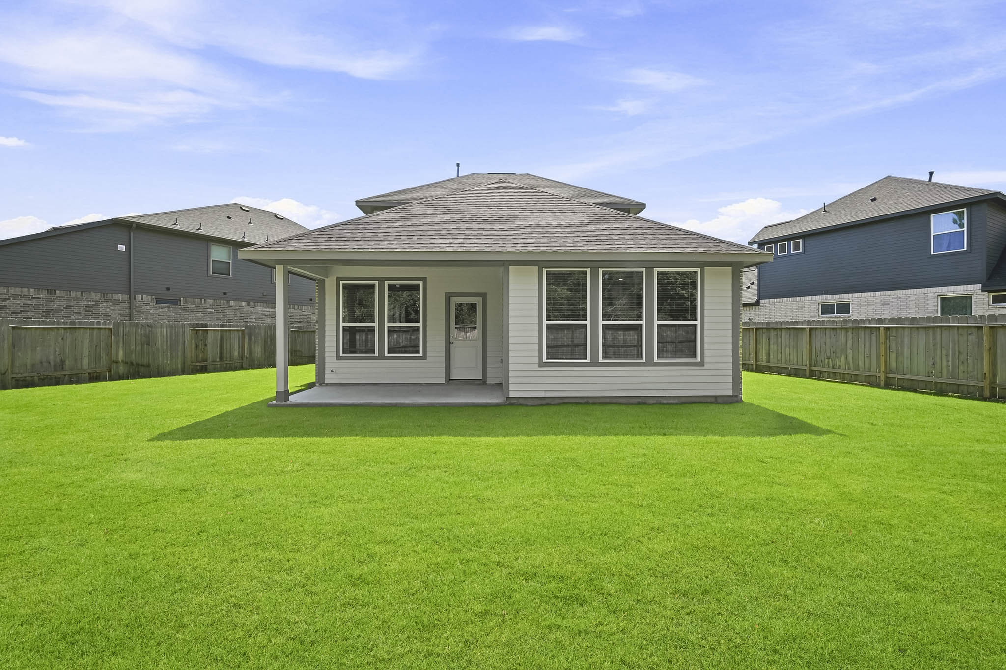 A house with a fence and grass.