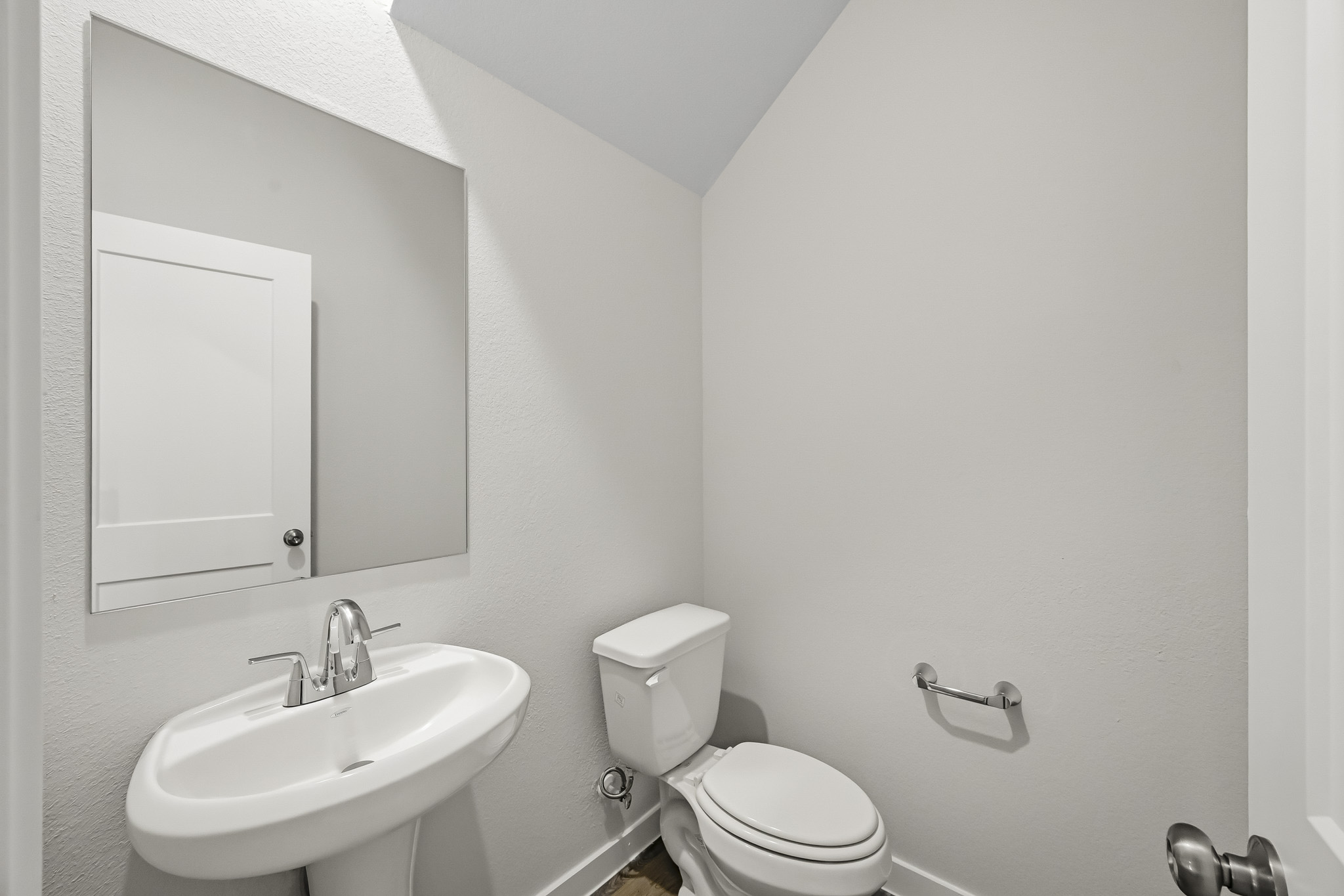 A bathroom with a toilet and sink.