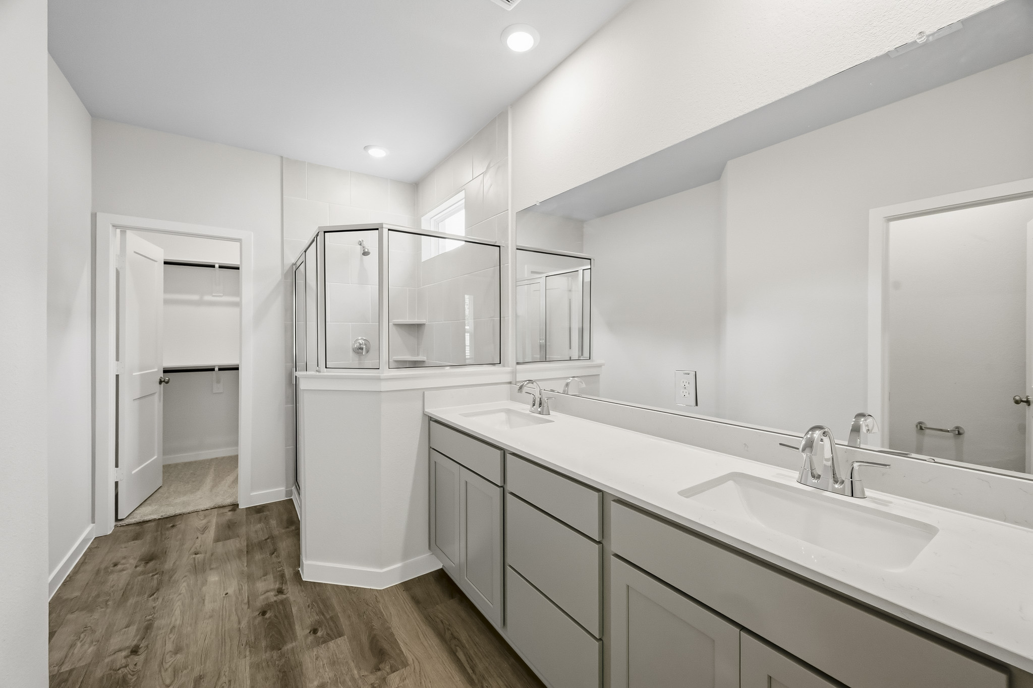 A bathroom with a large mirror.