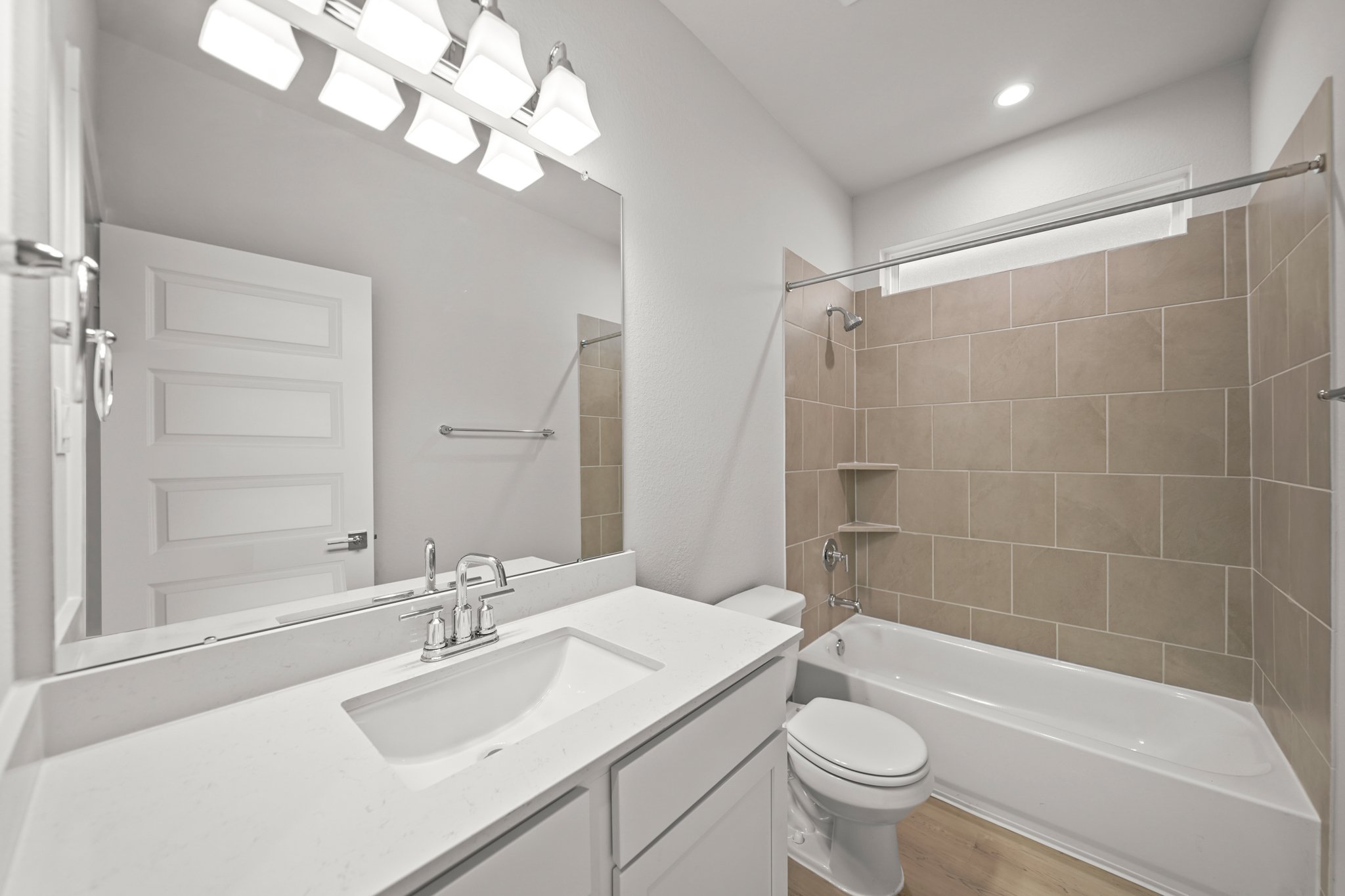 A bathroom with a tub sink and toilet.