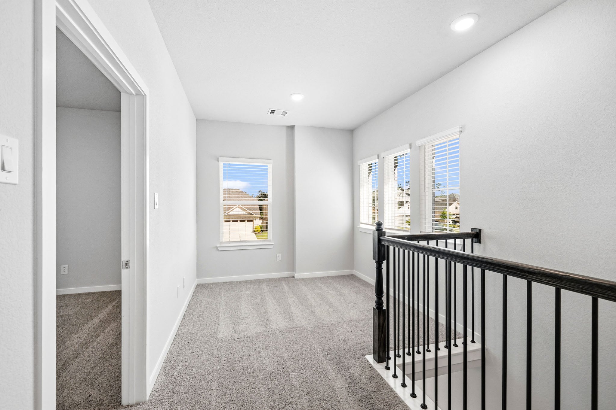 A hallway with a railing.