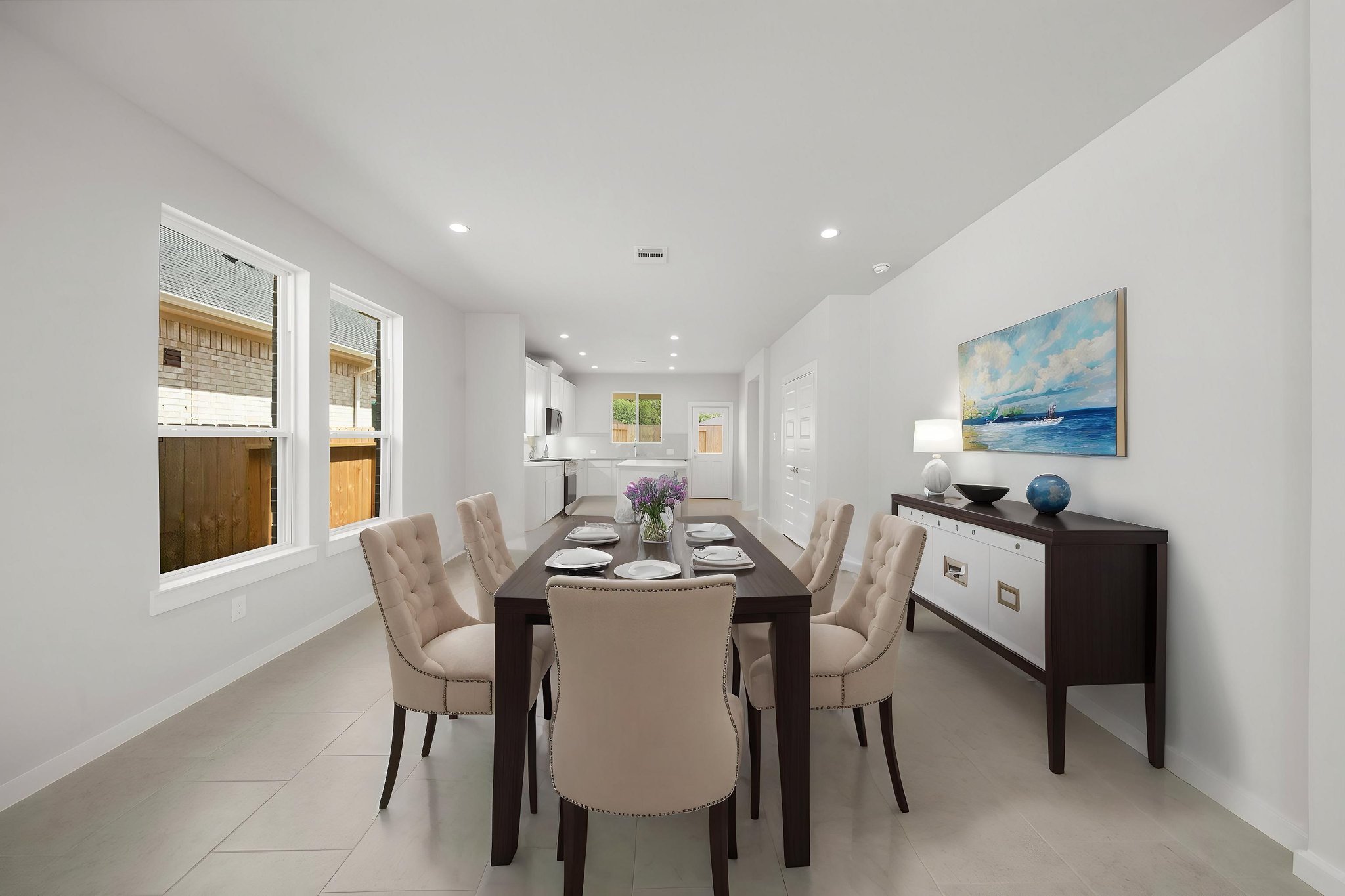 A dining room with a table and chairs.