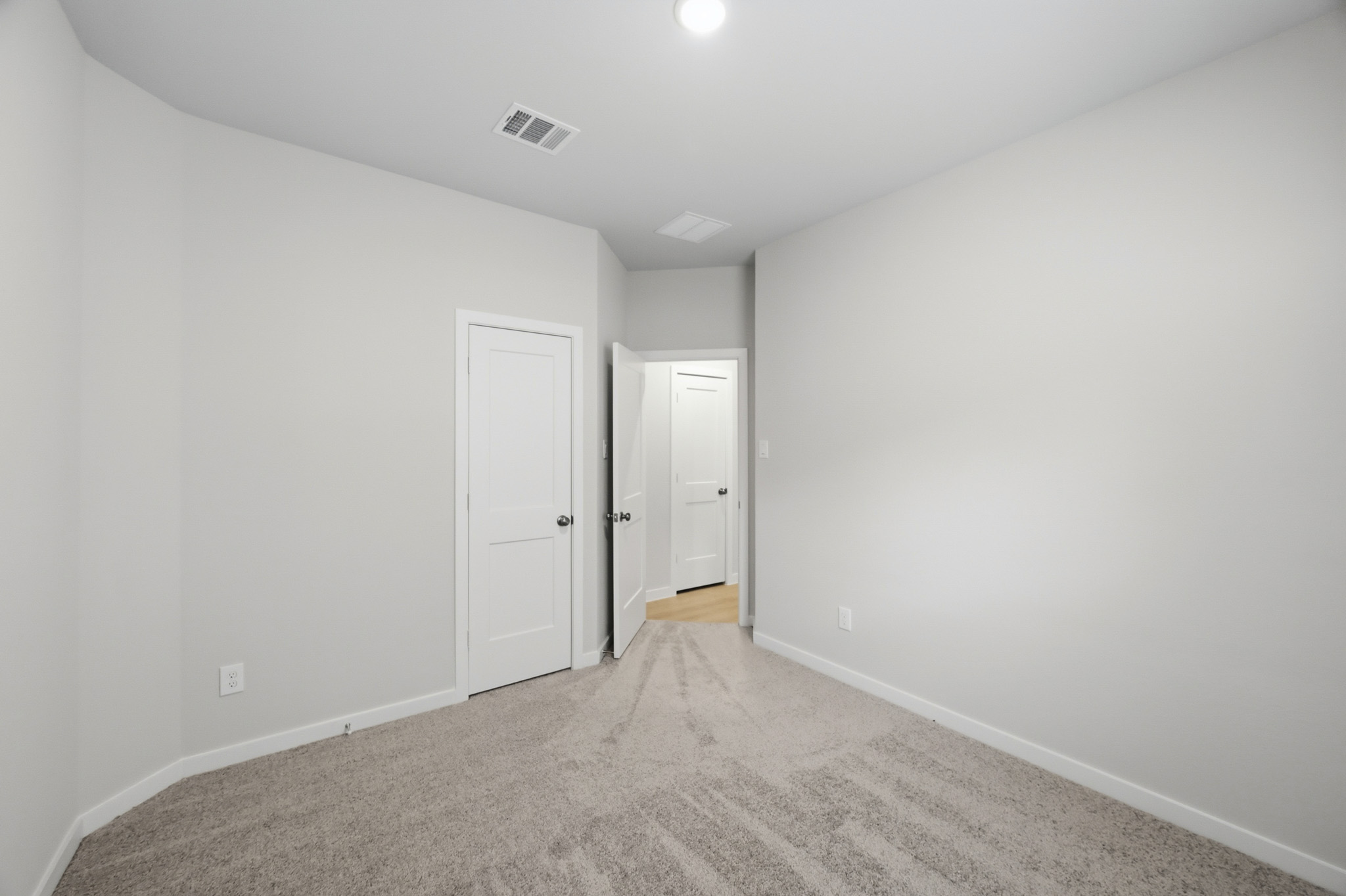 A hallway with white doors.