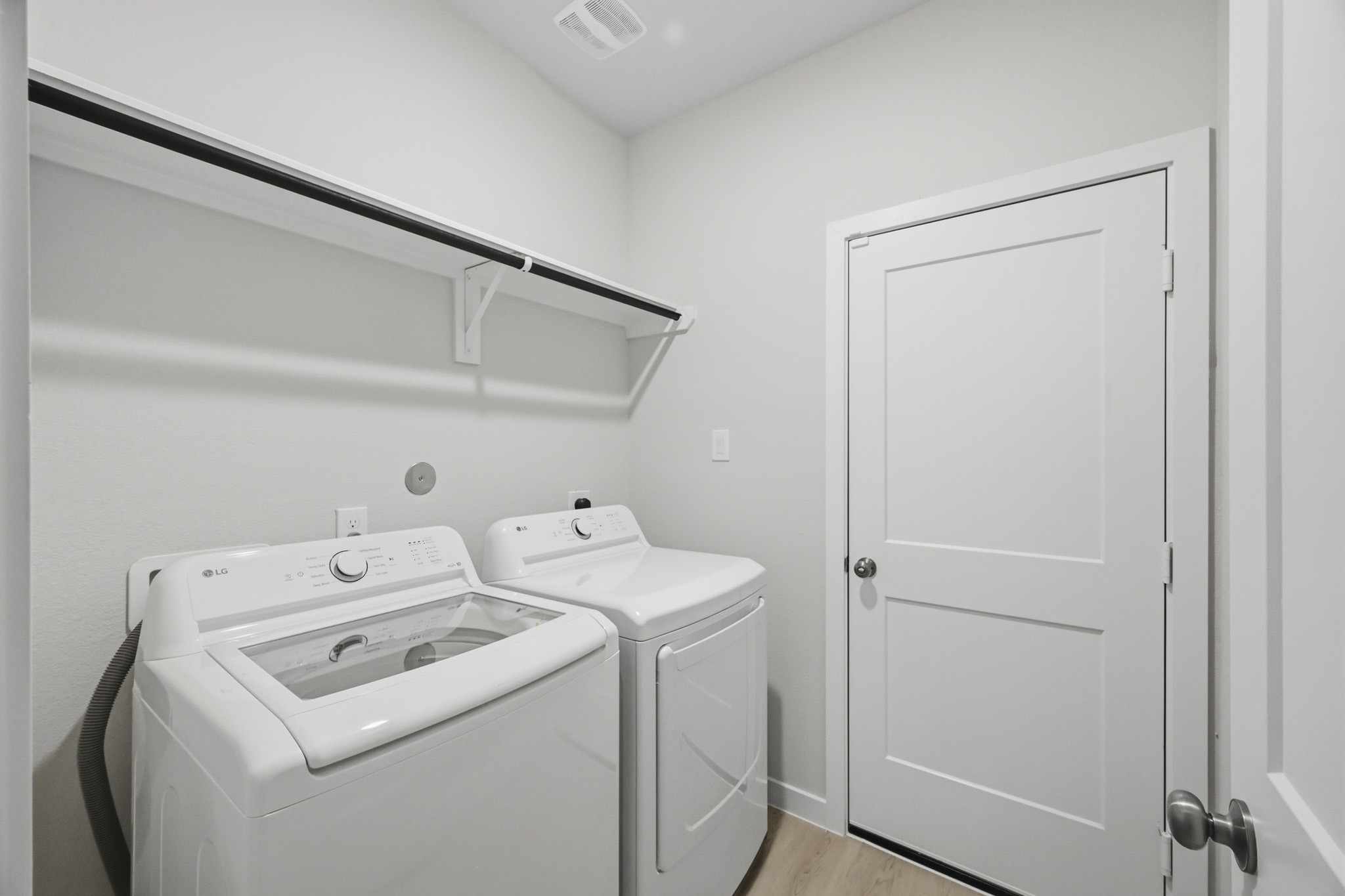 A white washer and dryer in a room.